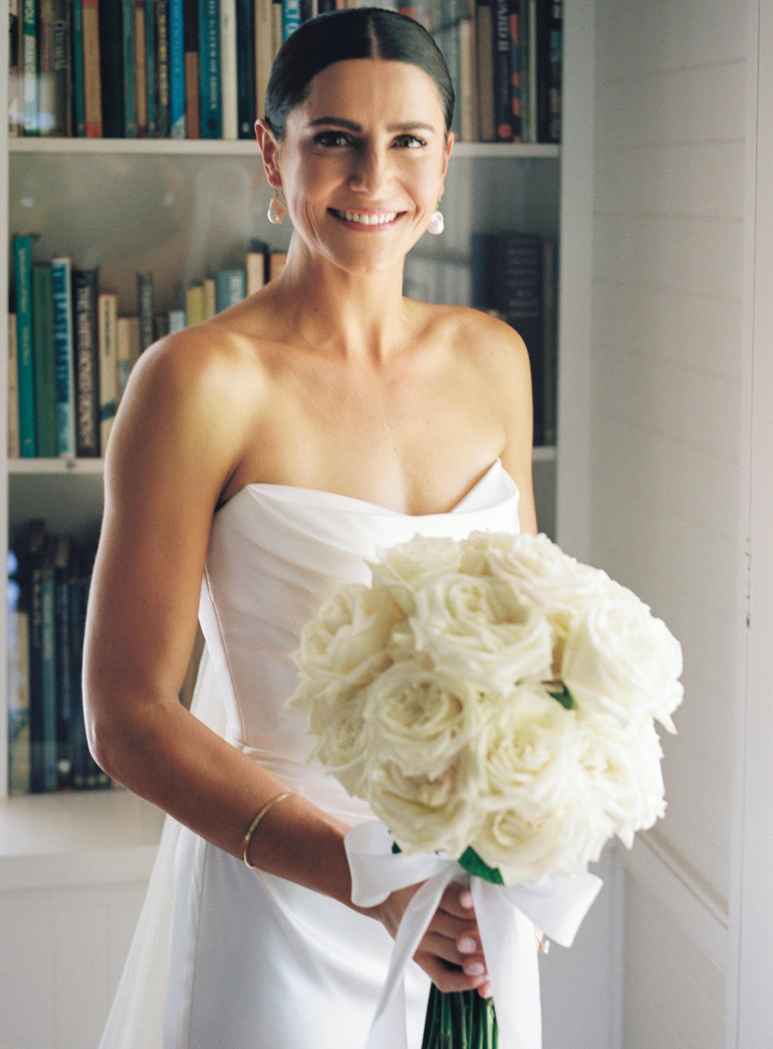 A woman wearing a white strapless dress and southern highlands wedding photographer 