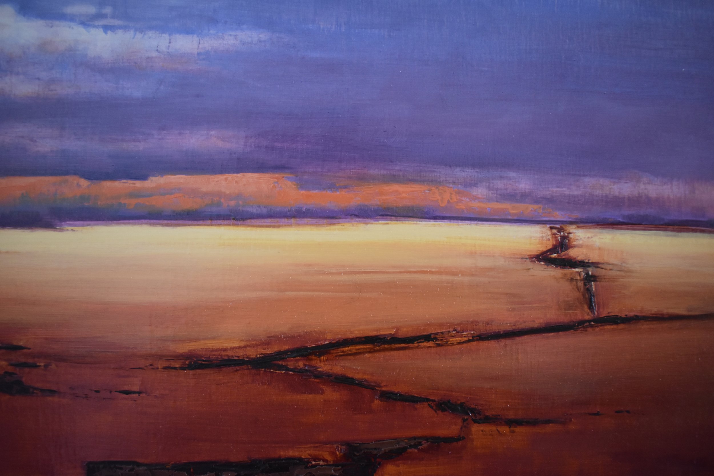 Close-up detail of Path Through The Storm by Kelly Sooter, highlighting the winding desert wash, luminous horizon, and layered atmospheric sky of the original oil painting.