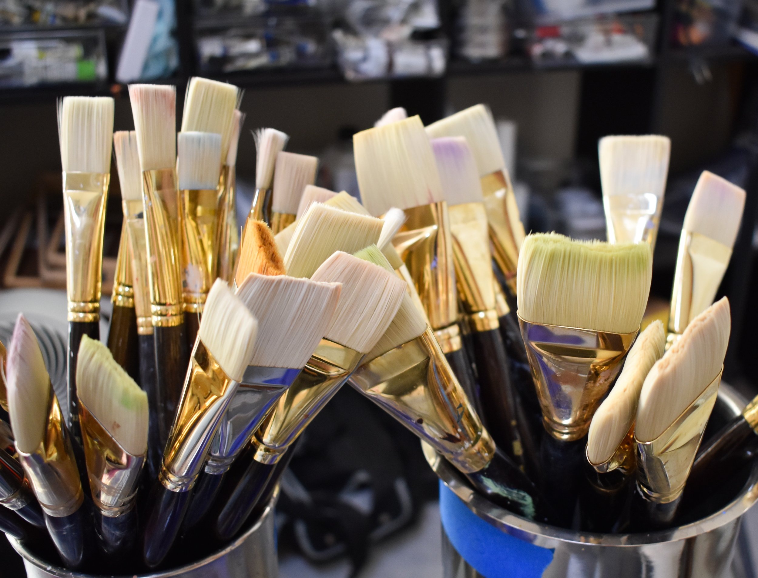 Artist brushes and oil painting materials in Kelly Sooter's studio, reflecting the craftsmanship and layered process behind her original experiential landscape oil paintings.
