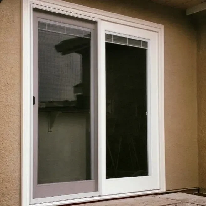 Sliding glass door with white frame and tinted glass, leading to an outdoor patio or balcony.
