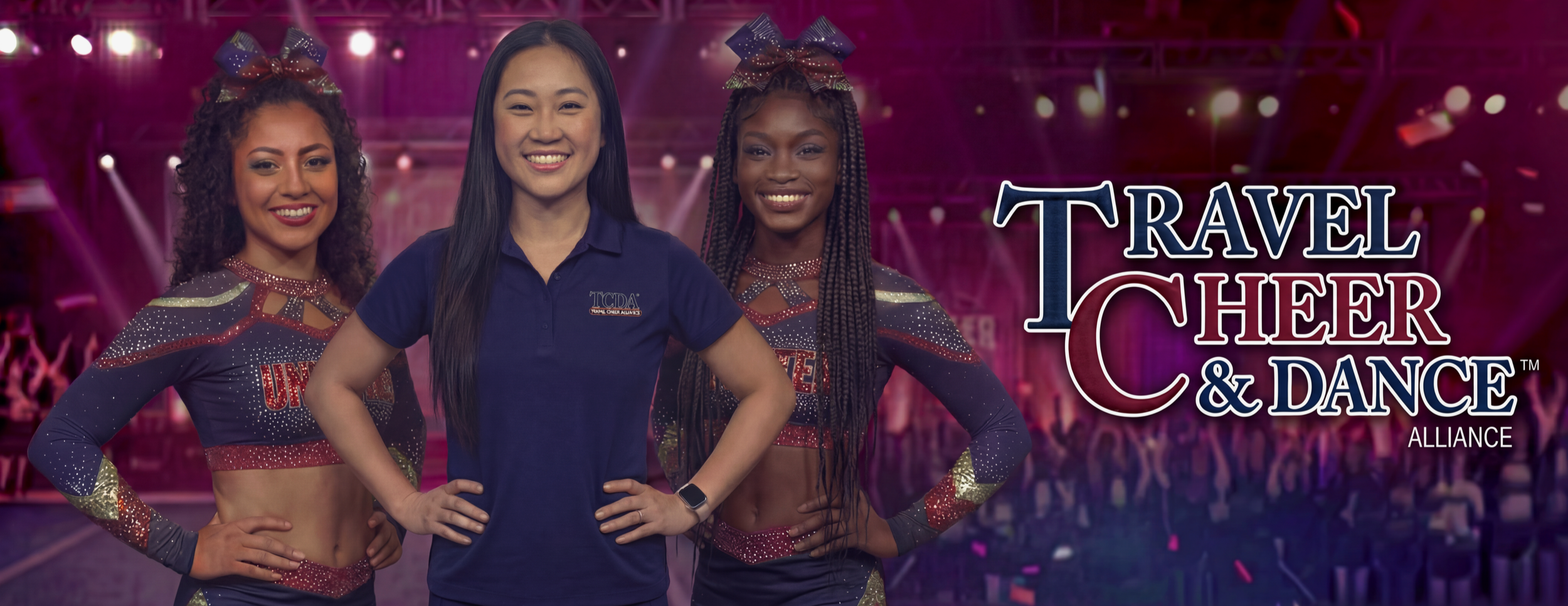 Three cheerleaders in uniform with a female coach in the center wearing a navy polo shirt, at a cheerleading event with a large crowd and stage in the background, with the text 'Travel Cheer & Dance Alliance'.
