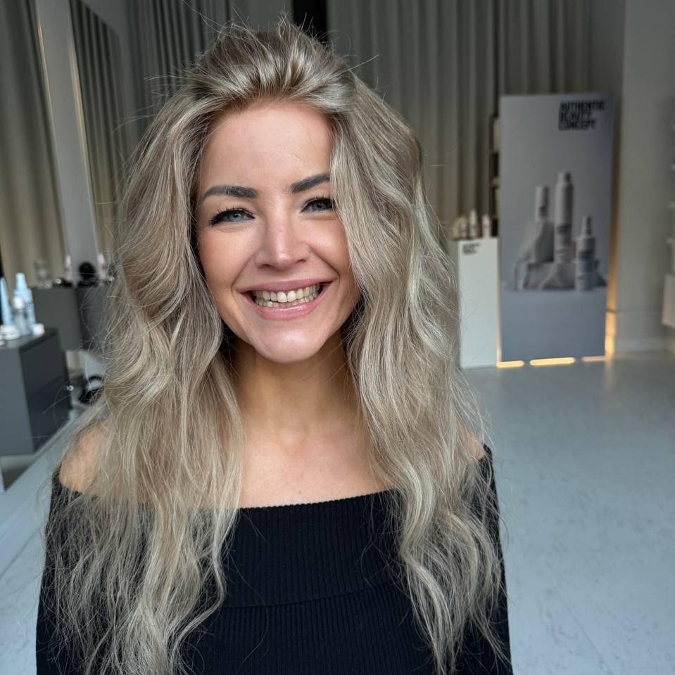 A woman wearing a natural looking blond wig