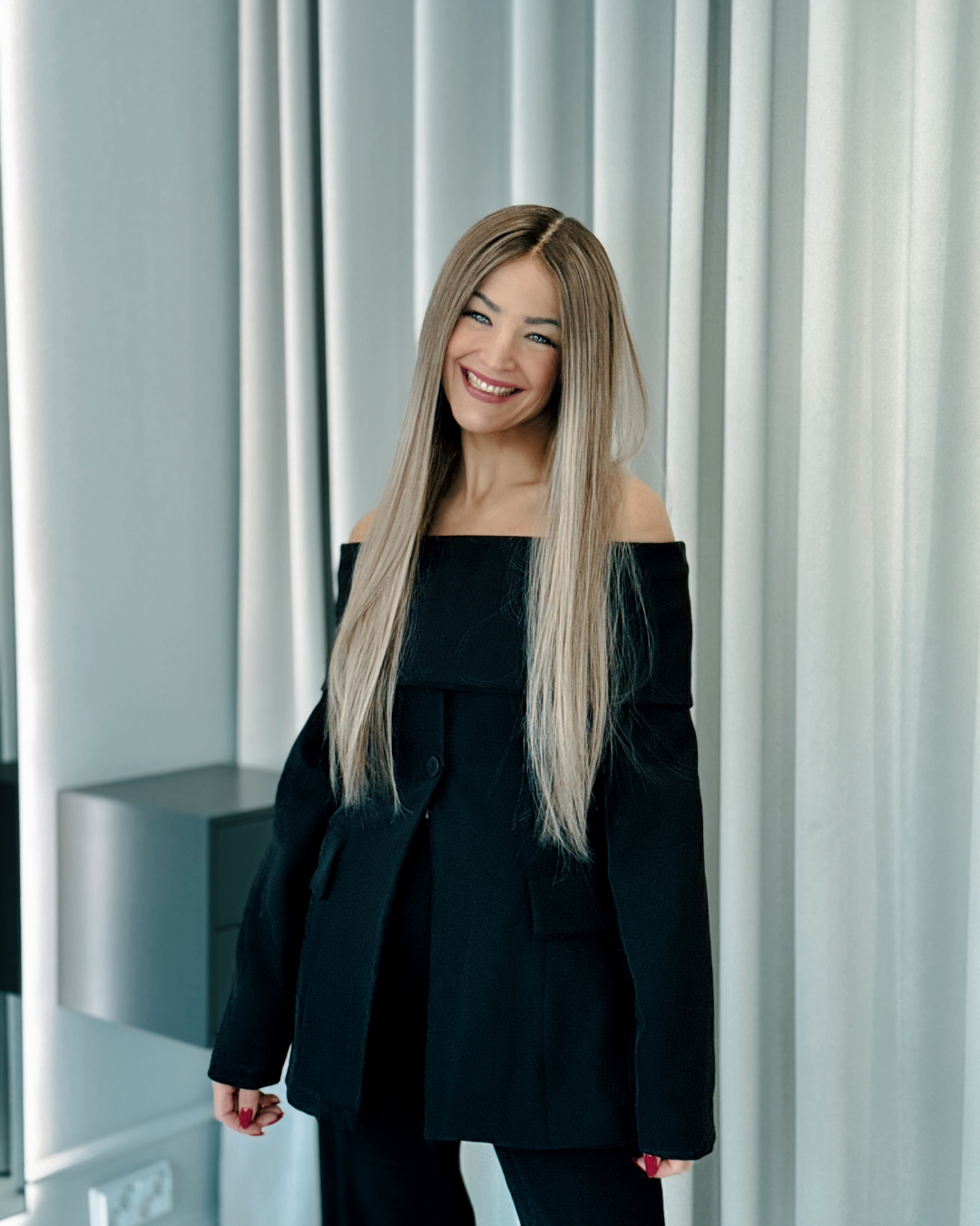 A woman smiling with long blonde human hair wig