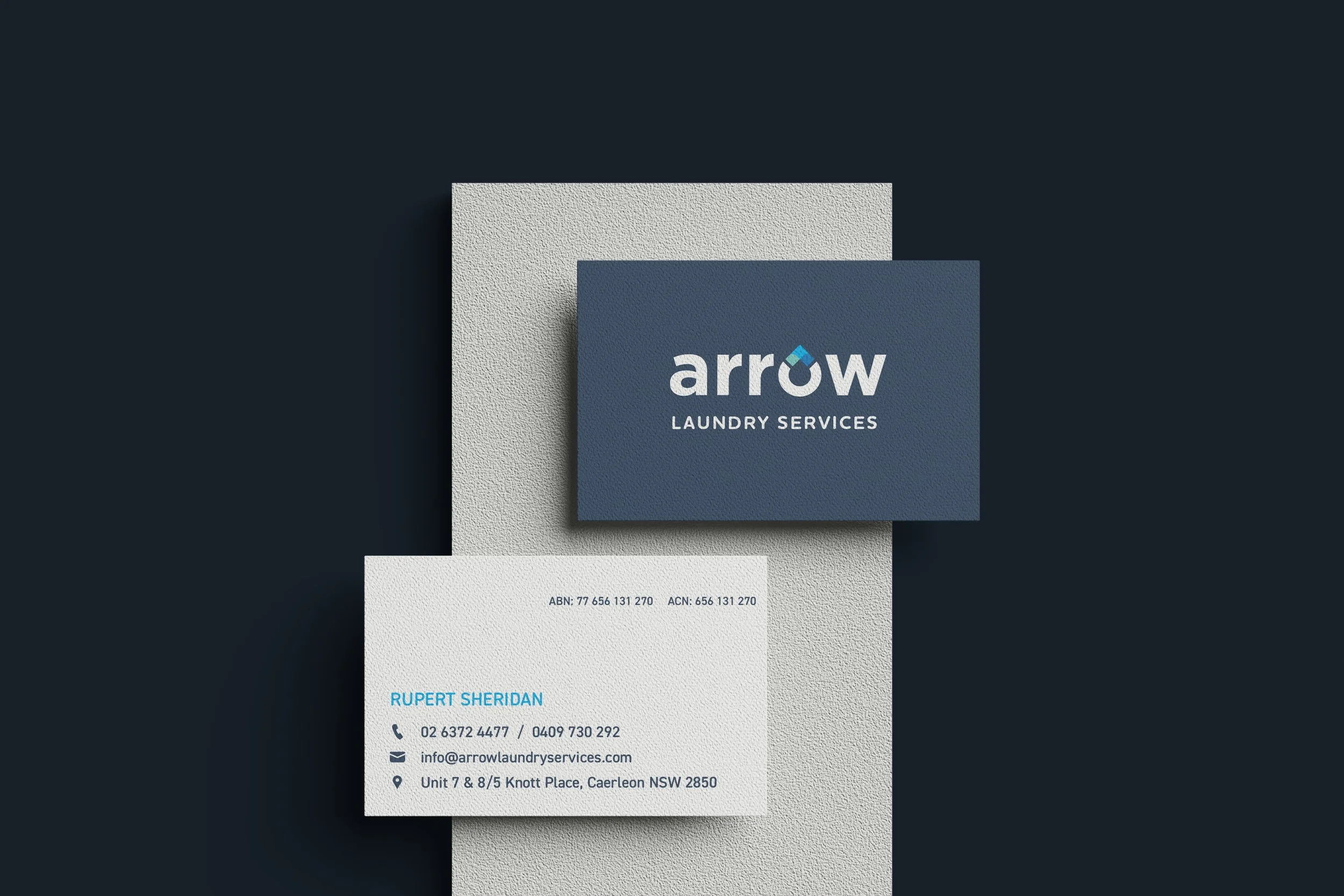 Business card for Arrow Laundry Services with contact information and logo.
