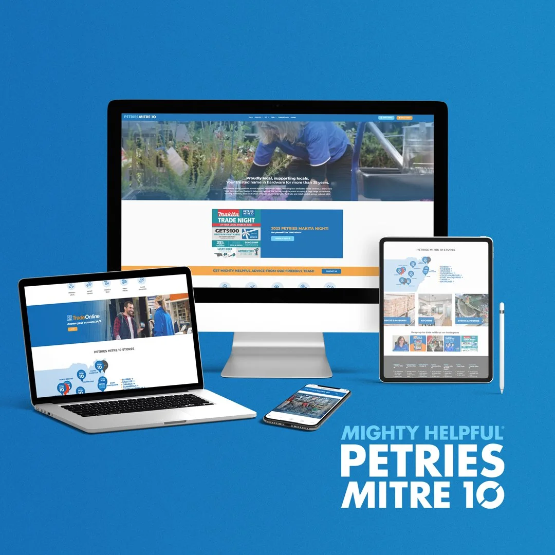 A display of digital devices including a desktop computer, a laptop, a tablet, and a smartphone on a blue background, all showing the PETRIES MITRE 10 website and related content.