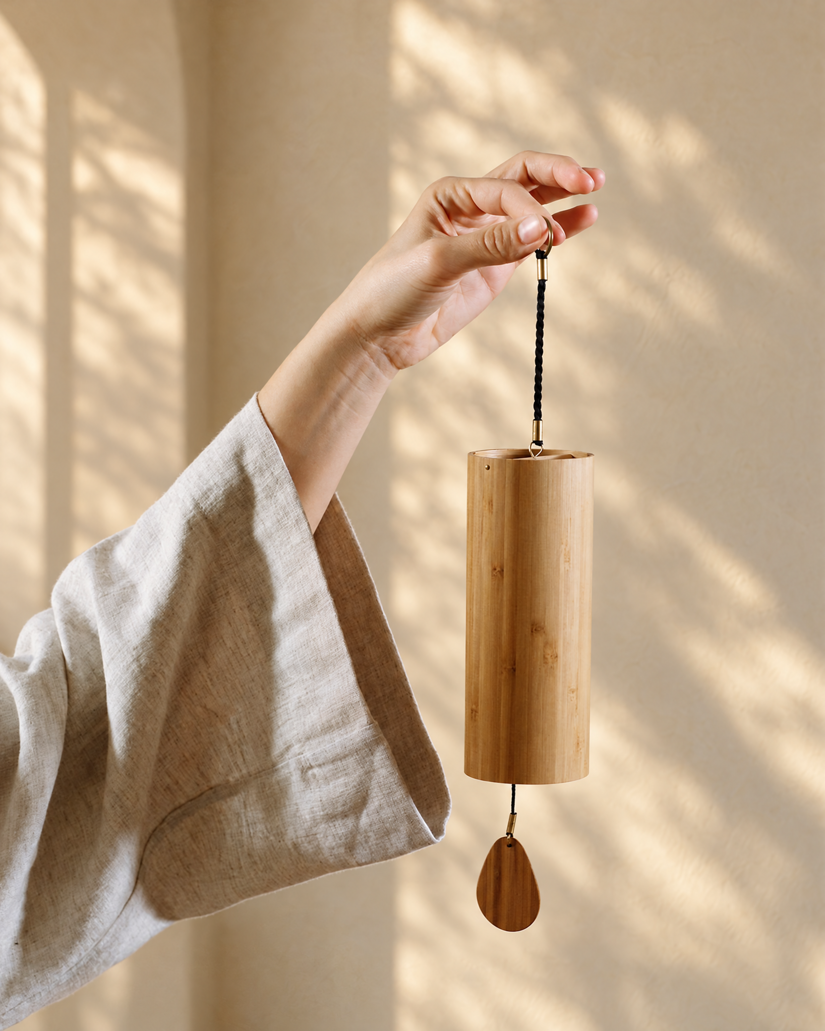 Sol Aragão holding a wooden chime during a Resonance sound healing session in Dubai.