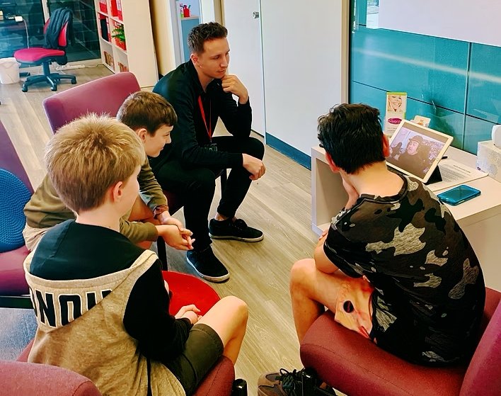 teacher and students watching iPad