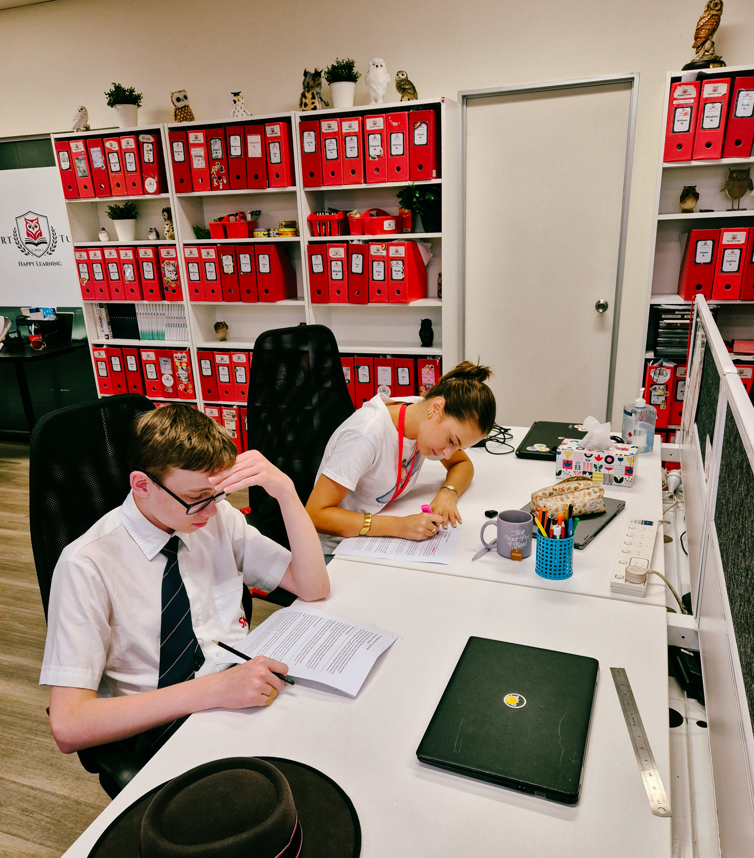 student and tutor working side by side at desk