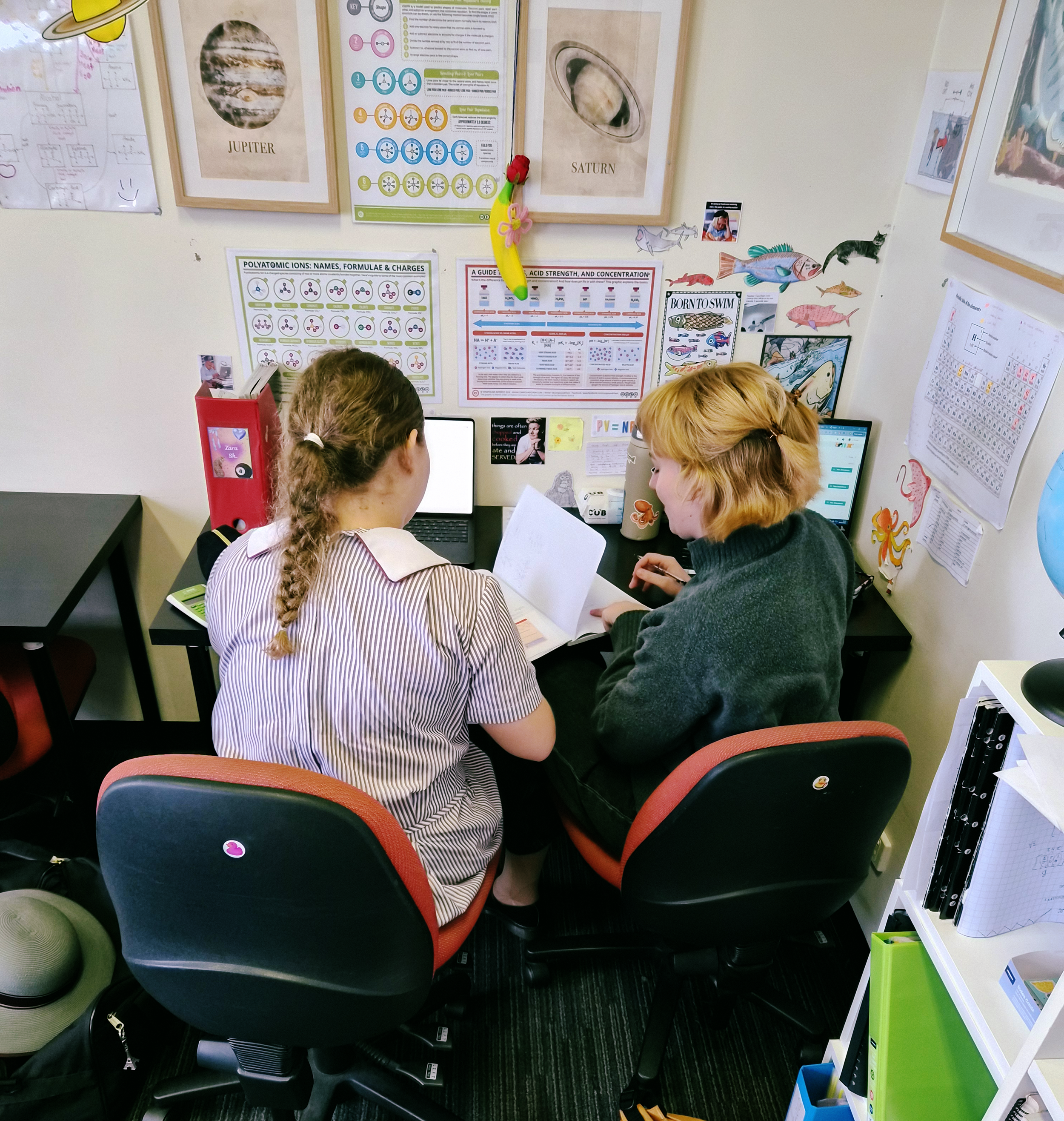 tutor working with girl at desk