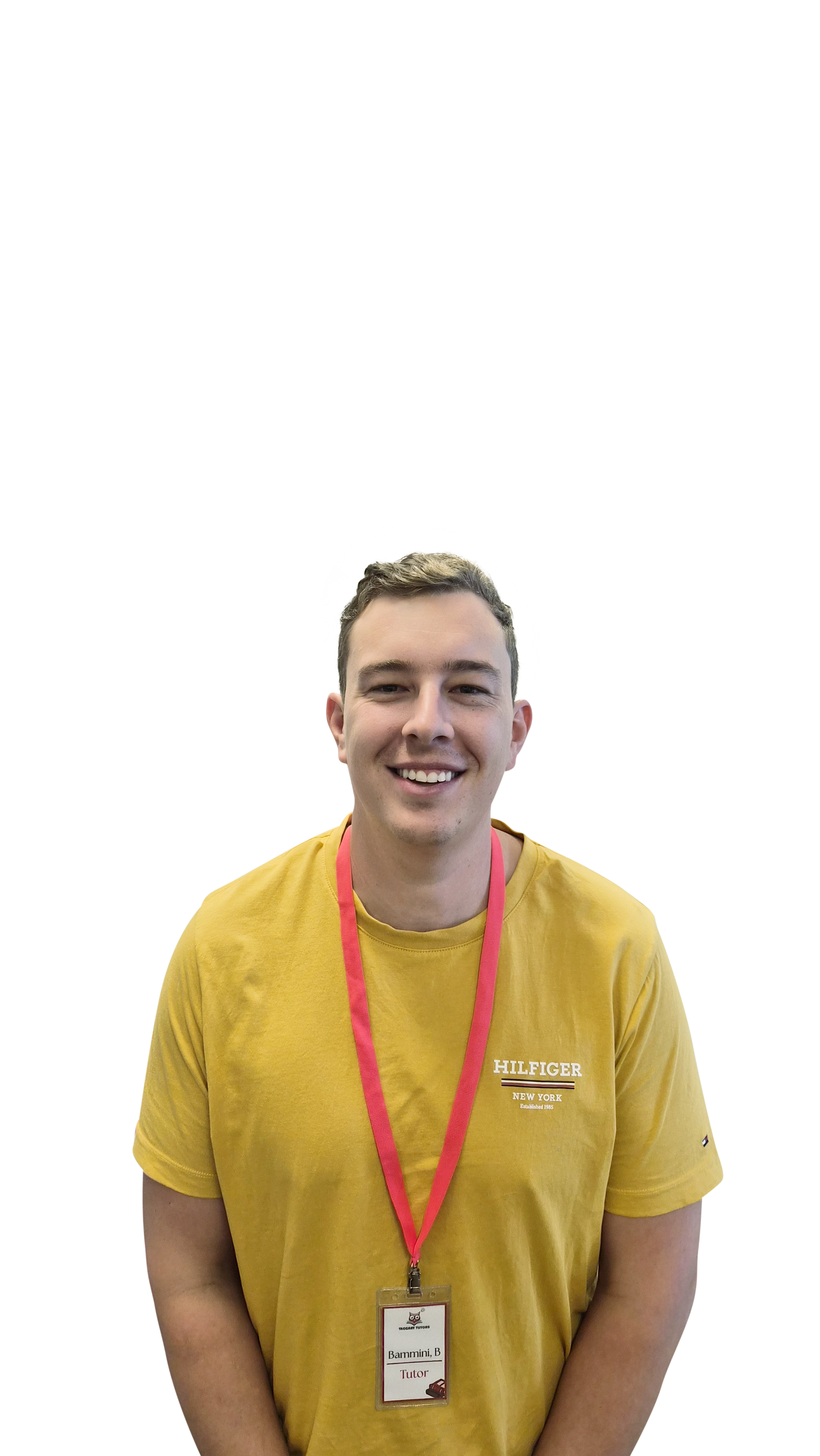 Young man smiling, wearing yellow Tommy Hilfiger T-shirt and a red lanyard with a badge that says Tutor.