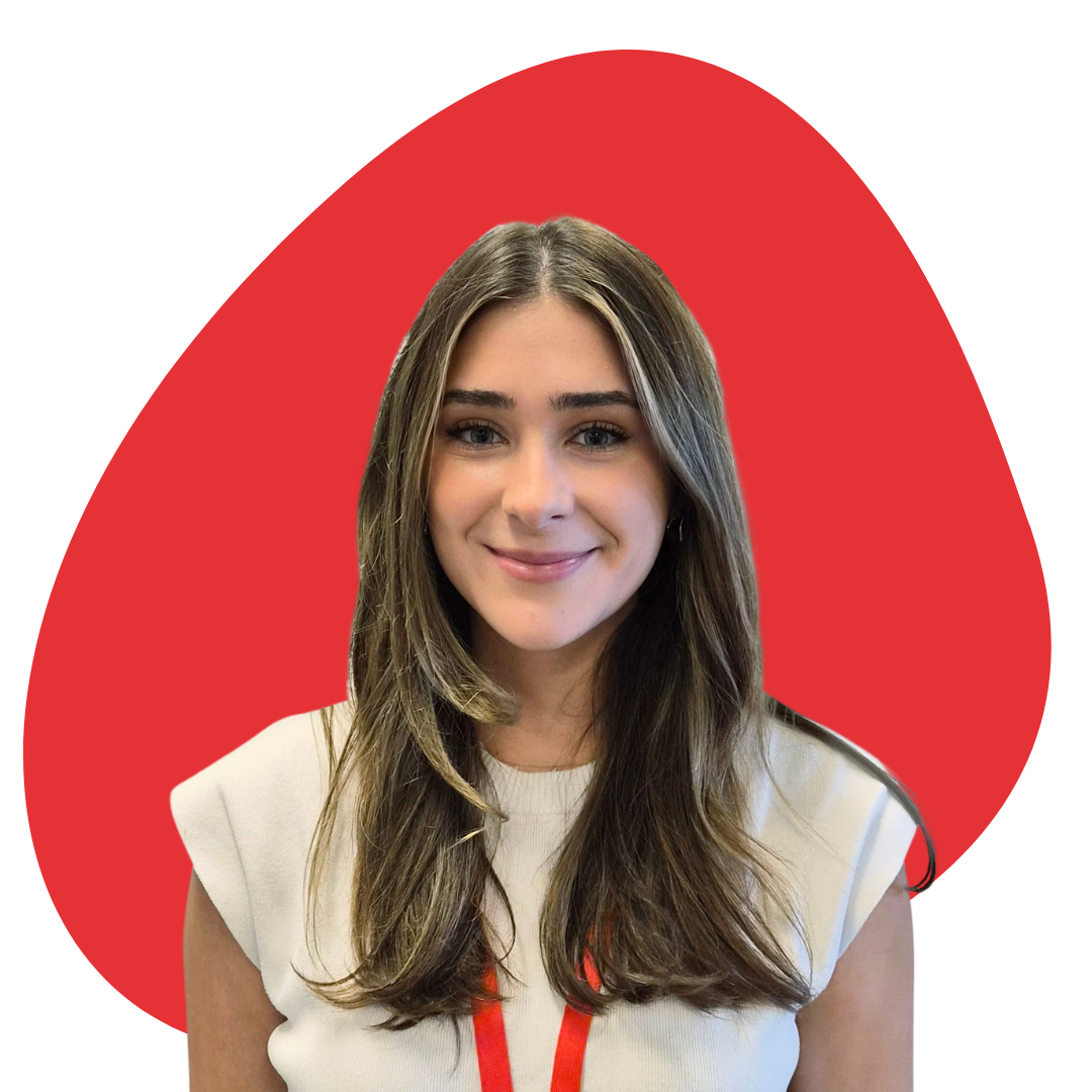 Portrait of a young woman with long brown hair, smiling, wearing a white top with red lanyard, in front of a red abstract shape on a white background.