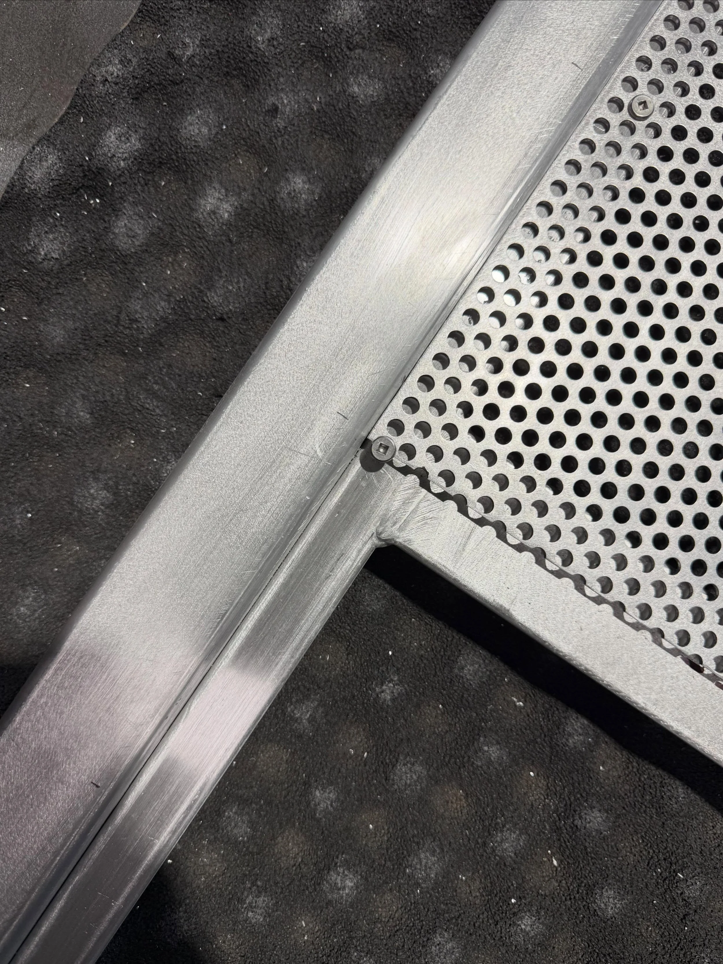 Pre powder coated perforated mesh gate. 3.5 metres long, swinging off one set of hinges, no wheel required. Big fan of a good hinge.
