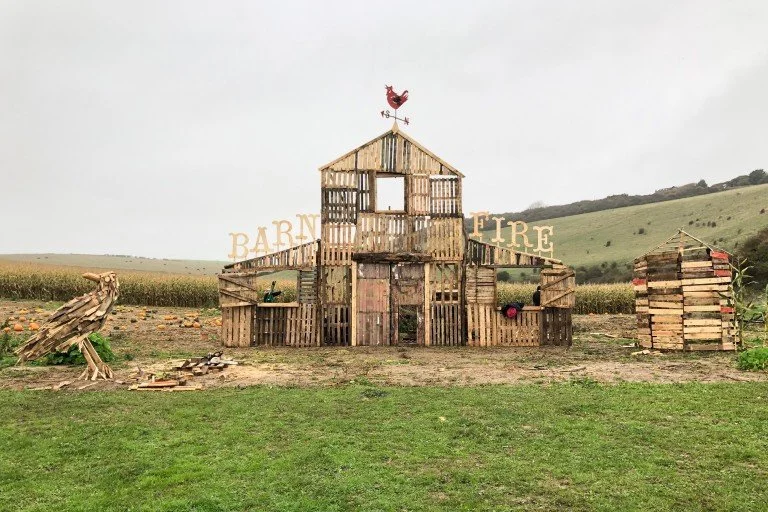 A rustic wooden barn and fire station structure with 