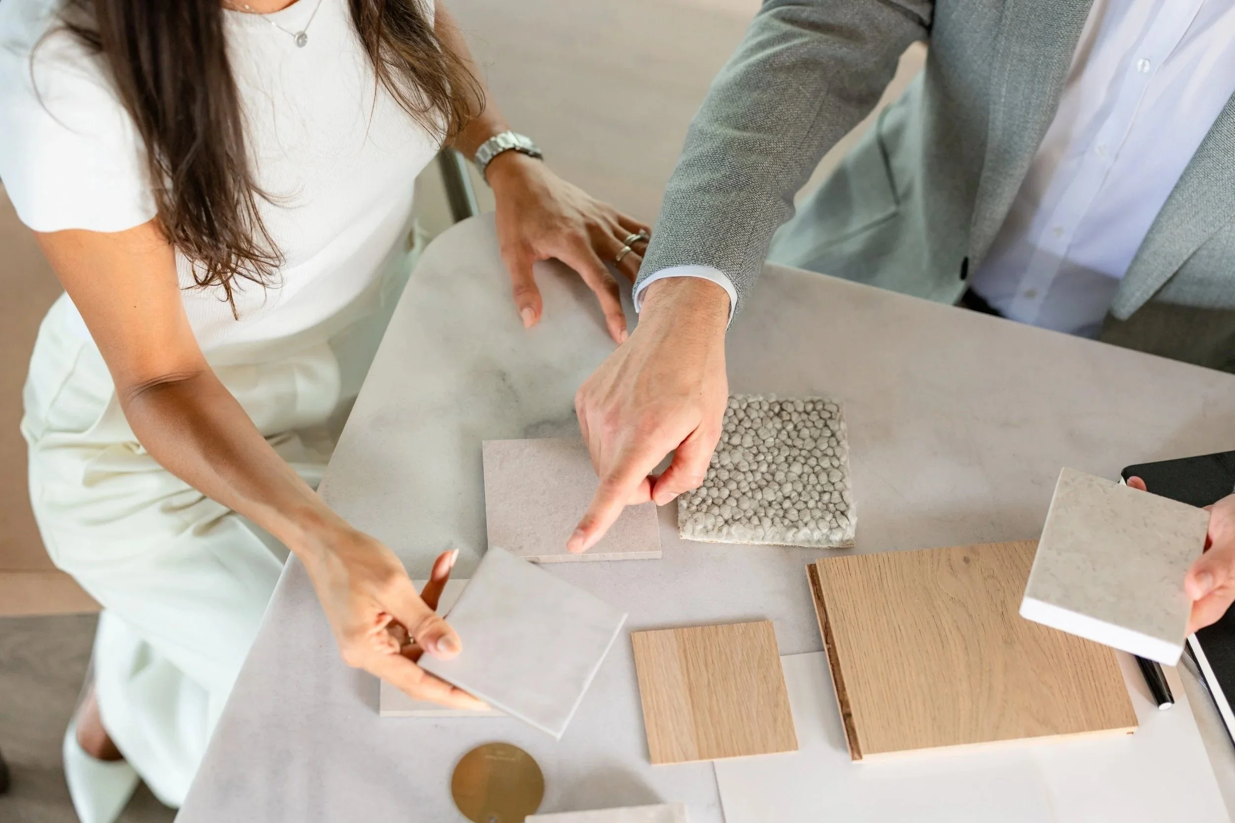 Two people are discussing interior design options for a boutique property development on Sydney's North Shore.