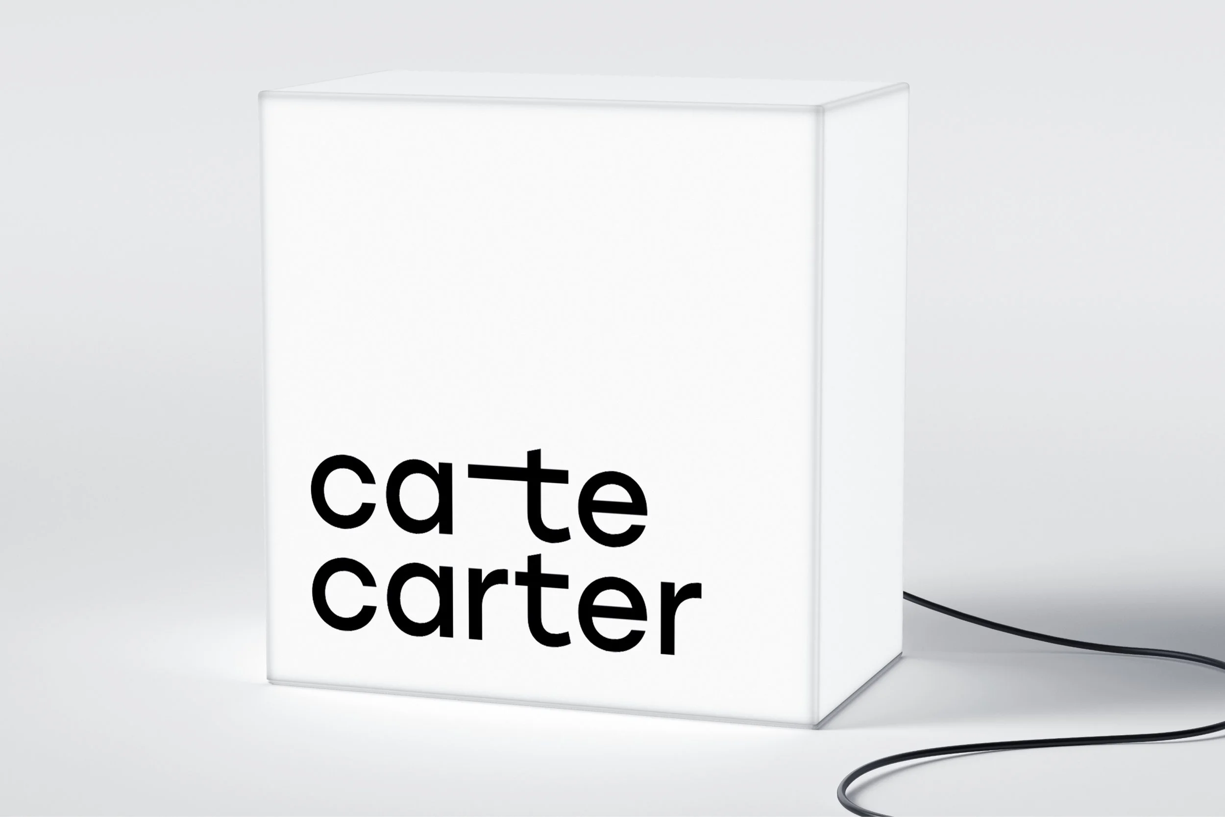 The Cate Carter logo on an illuminated light box.