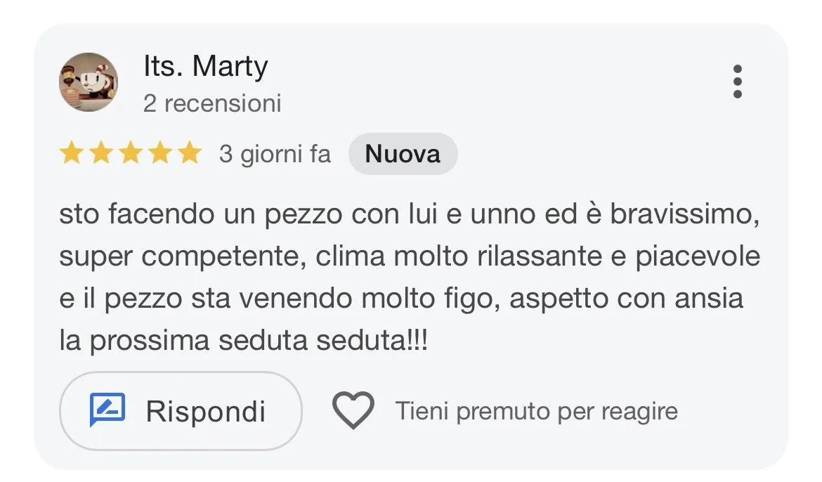Online review in Italian with five-star rating and profile picture of a cartoon character