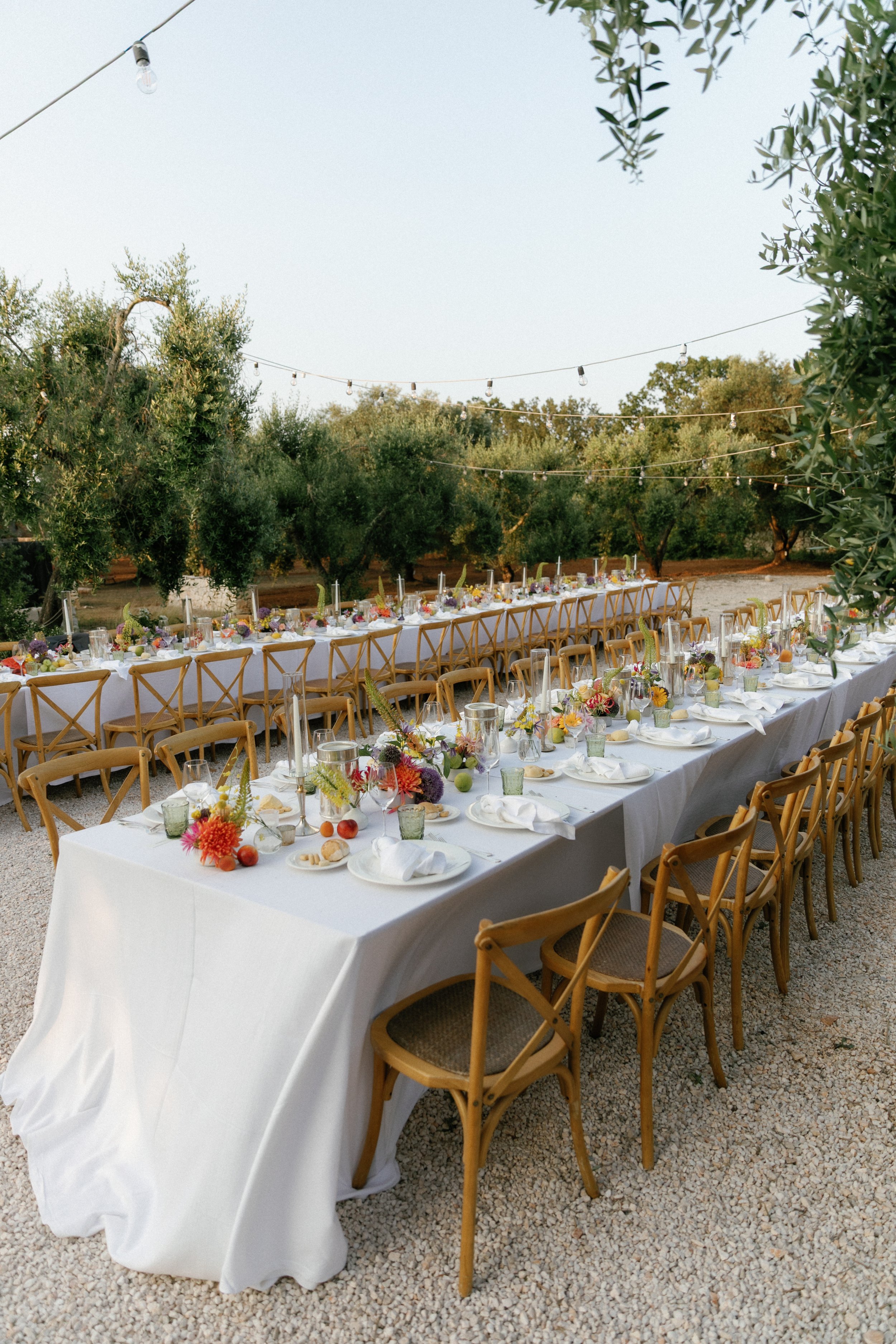 Puglia Italy destination wedding reception with long banquet tables and candlelight.