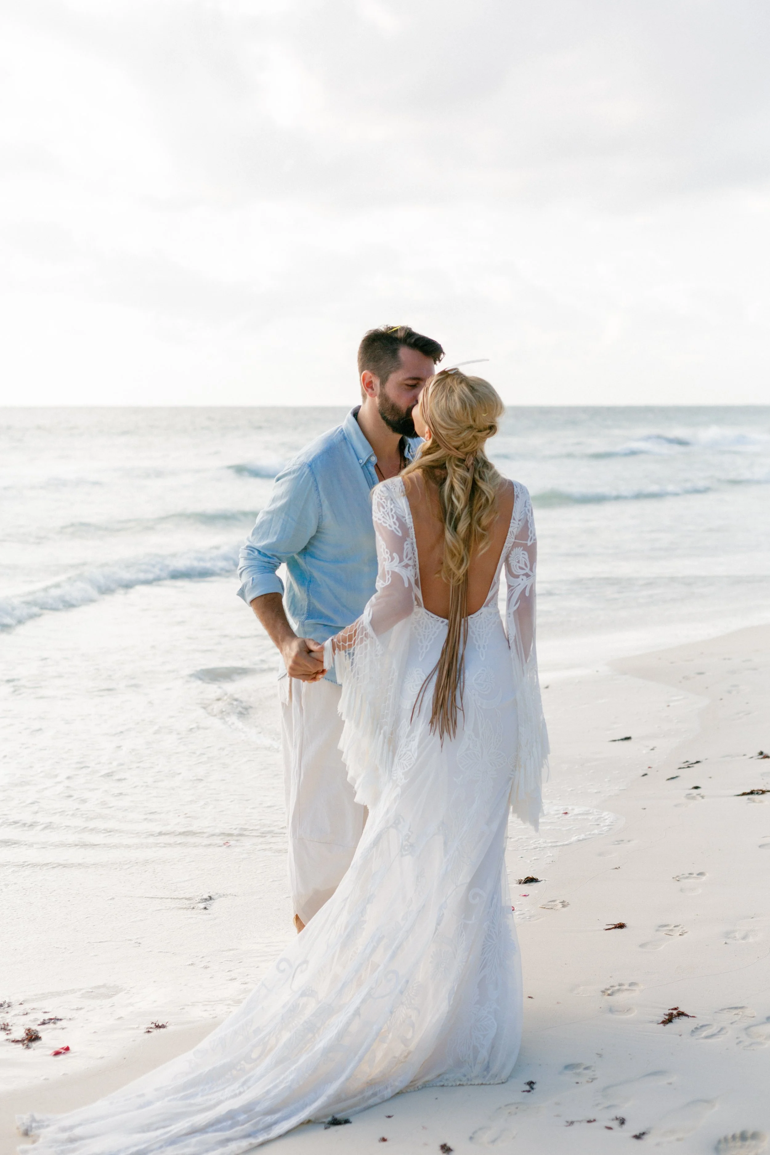 Destination wedding in Tulum, Mexico, couple kissing on the beach.