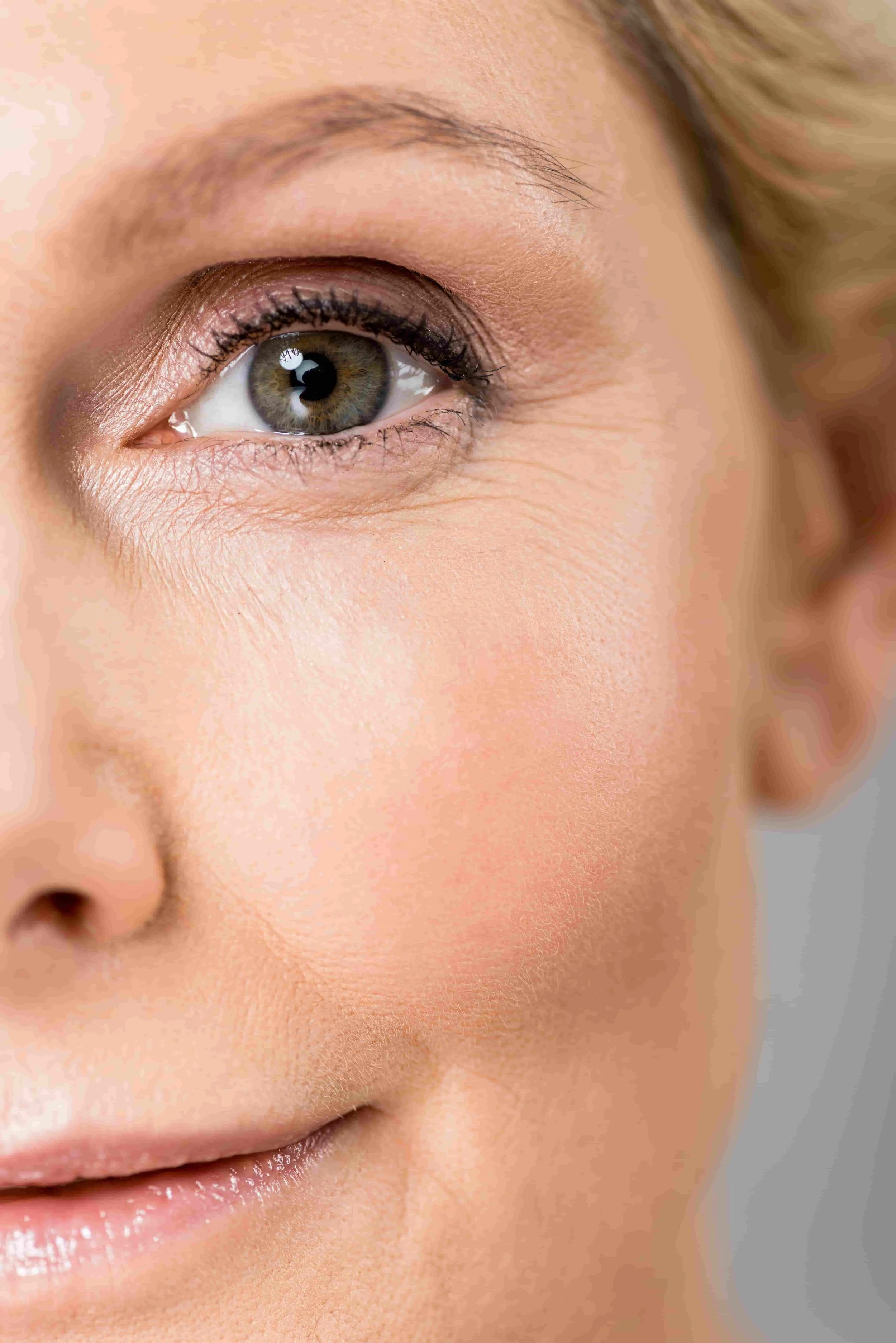 Nærbilde av en kvinnes ansikt, fokus på venstre øye og del av kinn og munn.