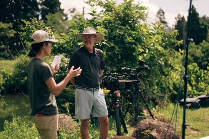 Director Paul Bonesteel with interpreter, Iiyama, Japan.jpg