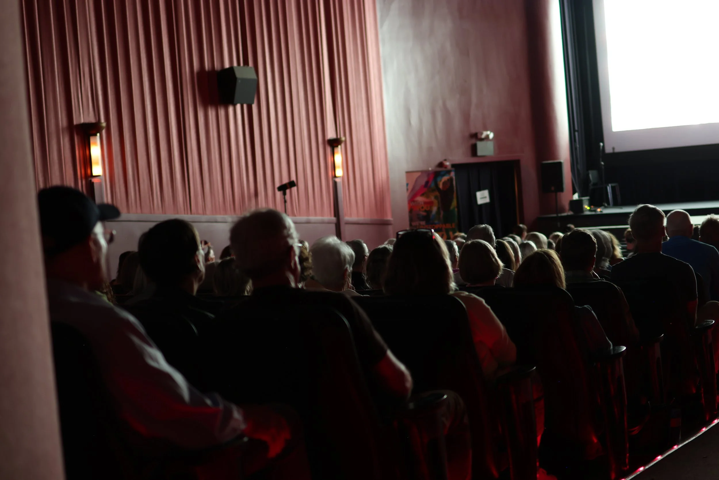 Audience watches "A Life Reimagined: The George Masa Story" at Asheville's Fine Arts Theater, April 29th, 2026