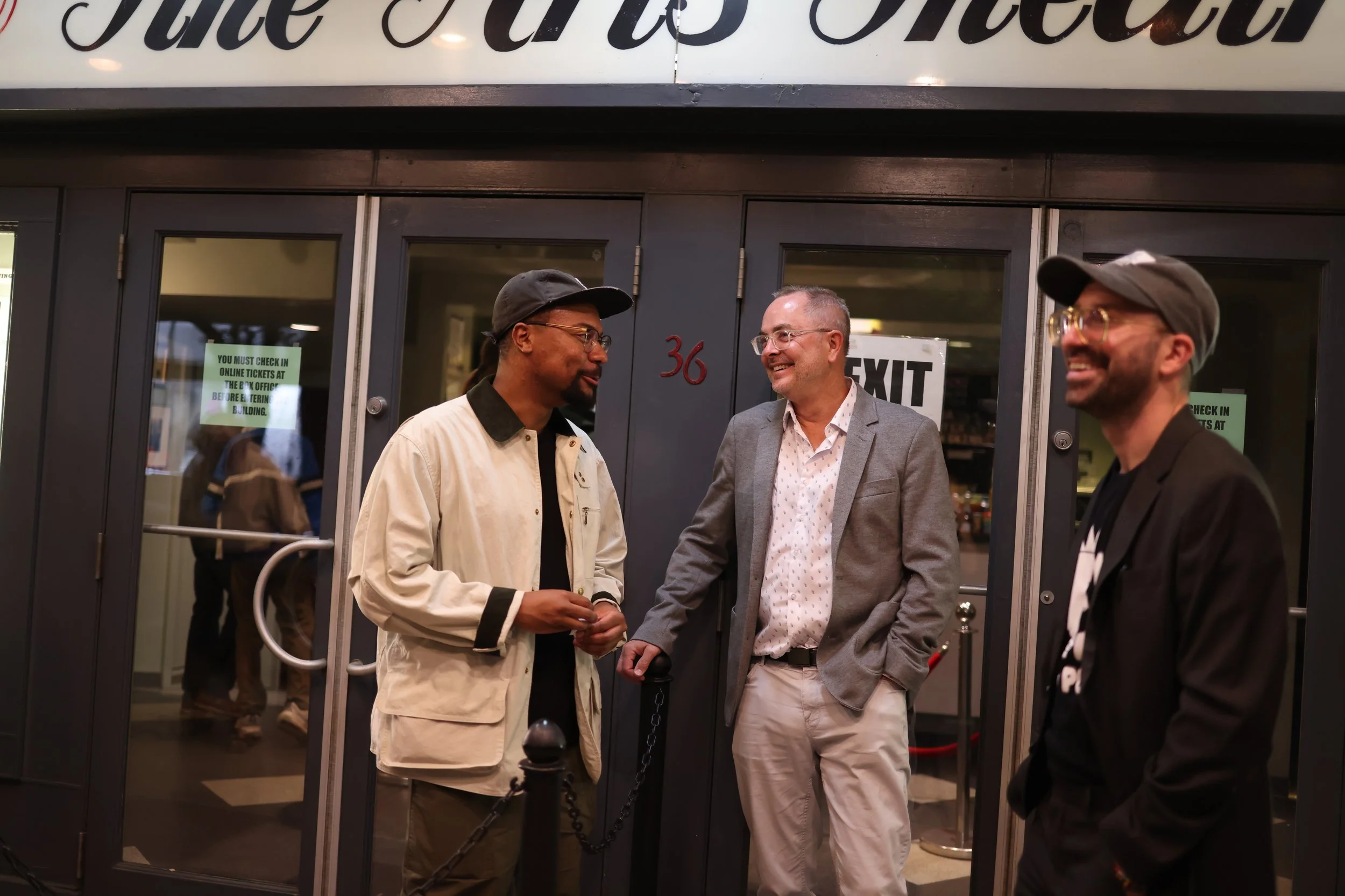 Camera Assistant Manny Figaro talks with Director Paul Bonesteel and PBS' James Mieczkowski