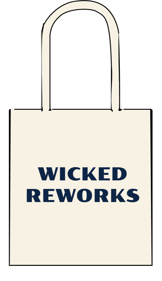 A beige tote bag with the words "WICKED REWORKS" printed in bold navy blue letters on the front.