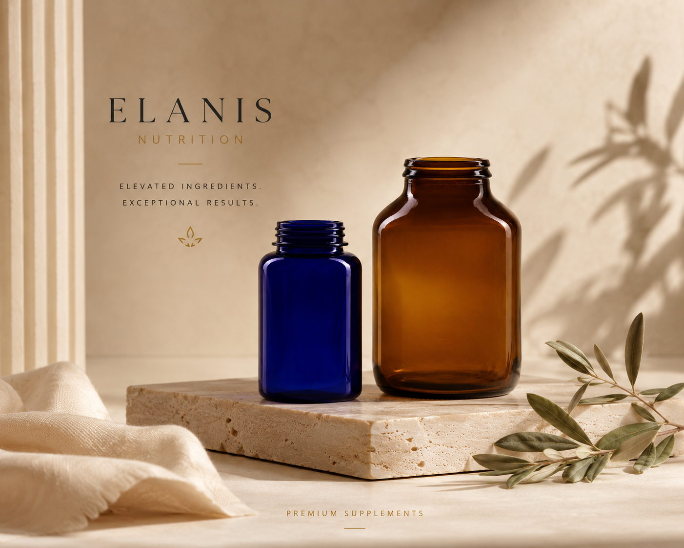 Two glass bottles, one dark blue and one amber, on a beige stone platform with a leafy branch and soft fabric nearby, and a beige background with shadows.