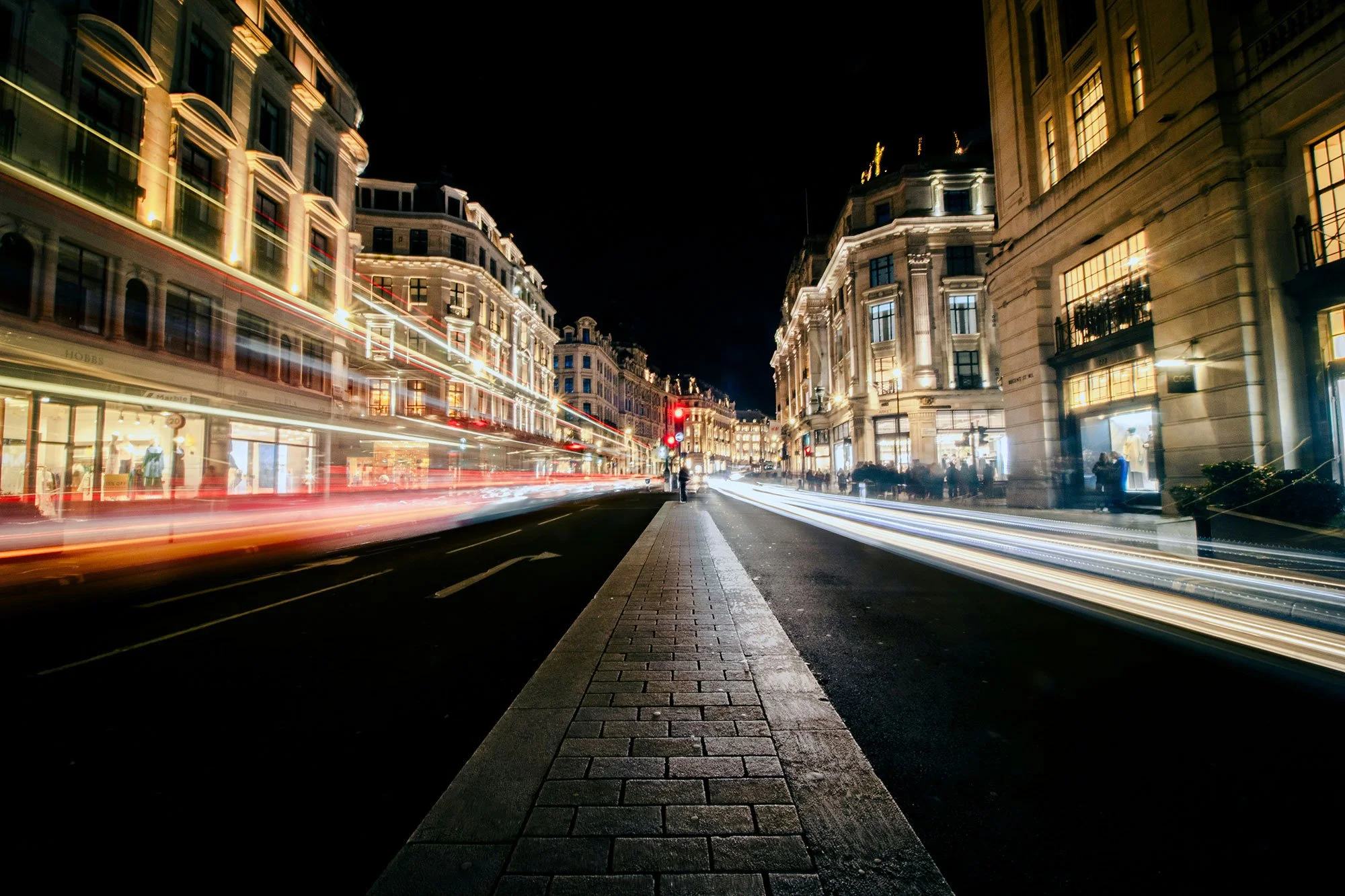 An energetic city centre road at night