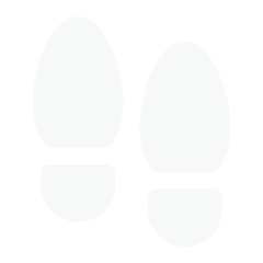 Silhouette of a pair of white shoe footprints on a black background