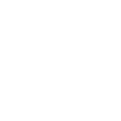 An overhead view of a motorcycle on a table, with a person wearing a white shirt seated nearby.