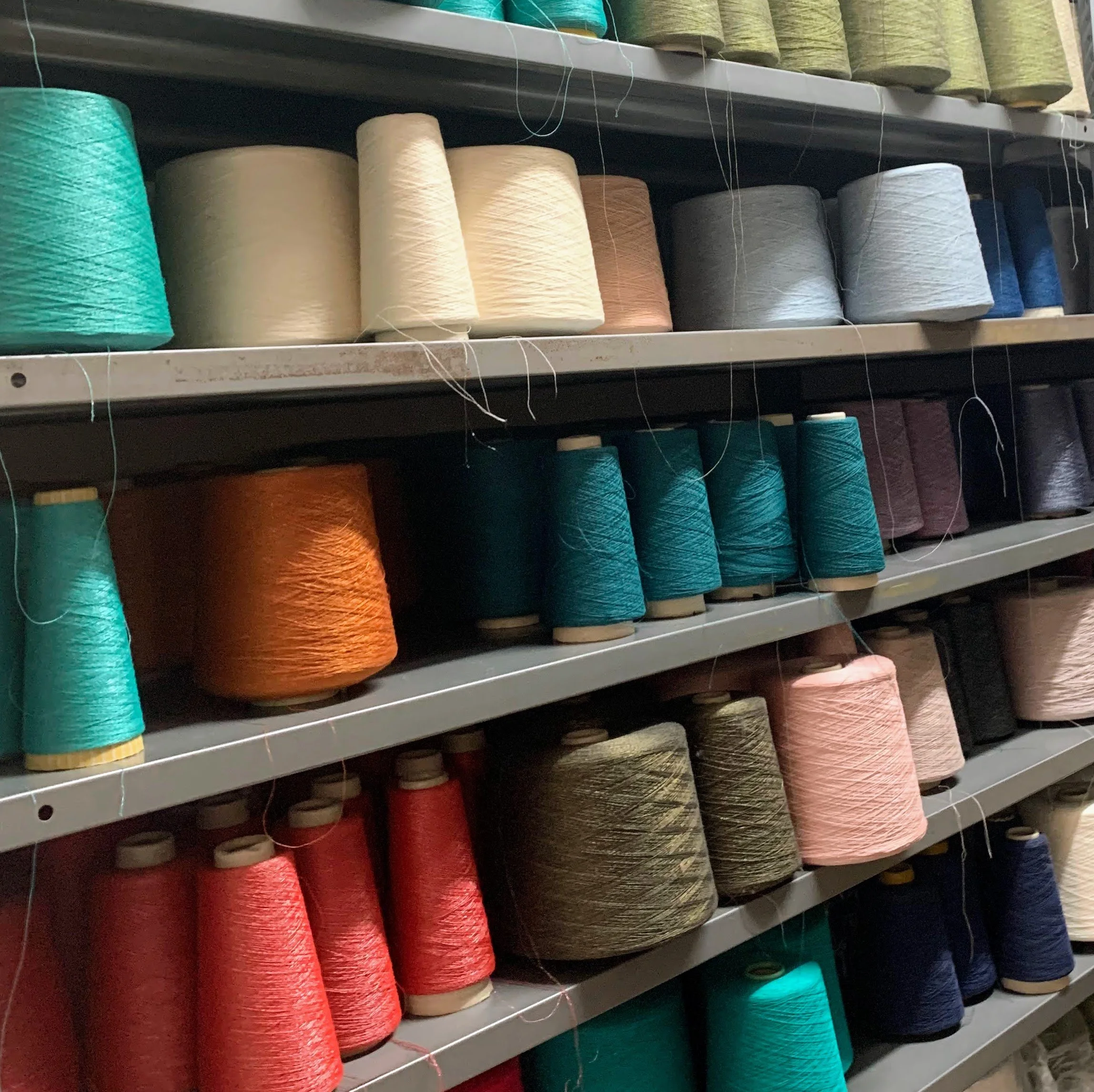 Shelves filled with large spools of colorful thread.