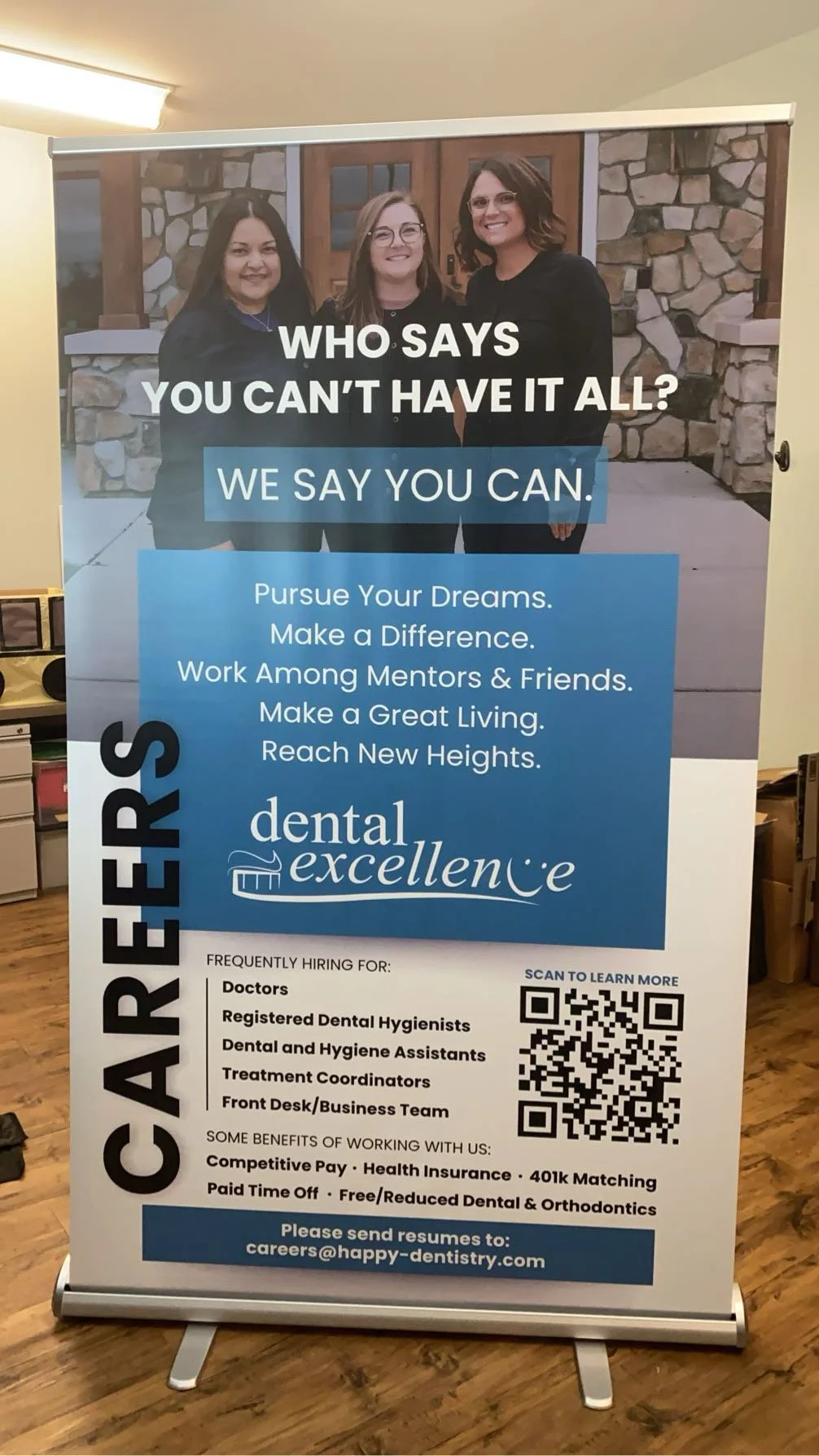 A recruitment poster for a dental practice featuring three women smiling in front of a stone building and advertising job openings for various dental positions.