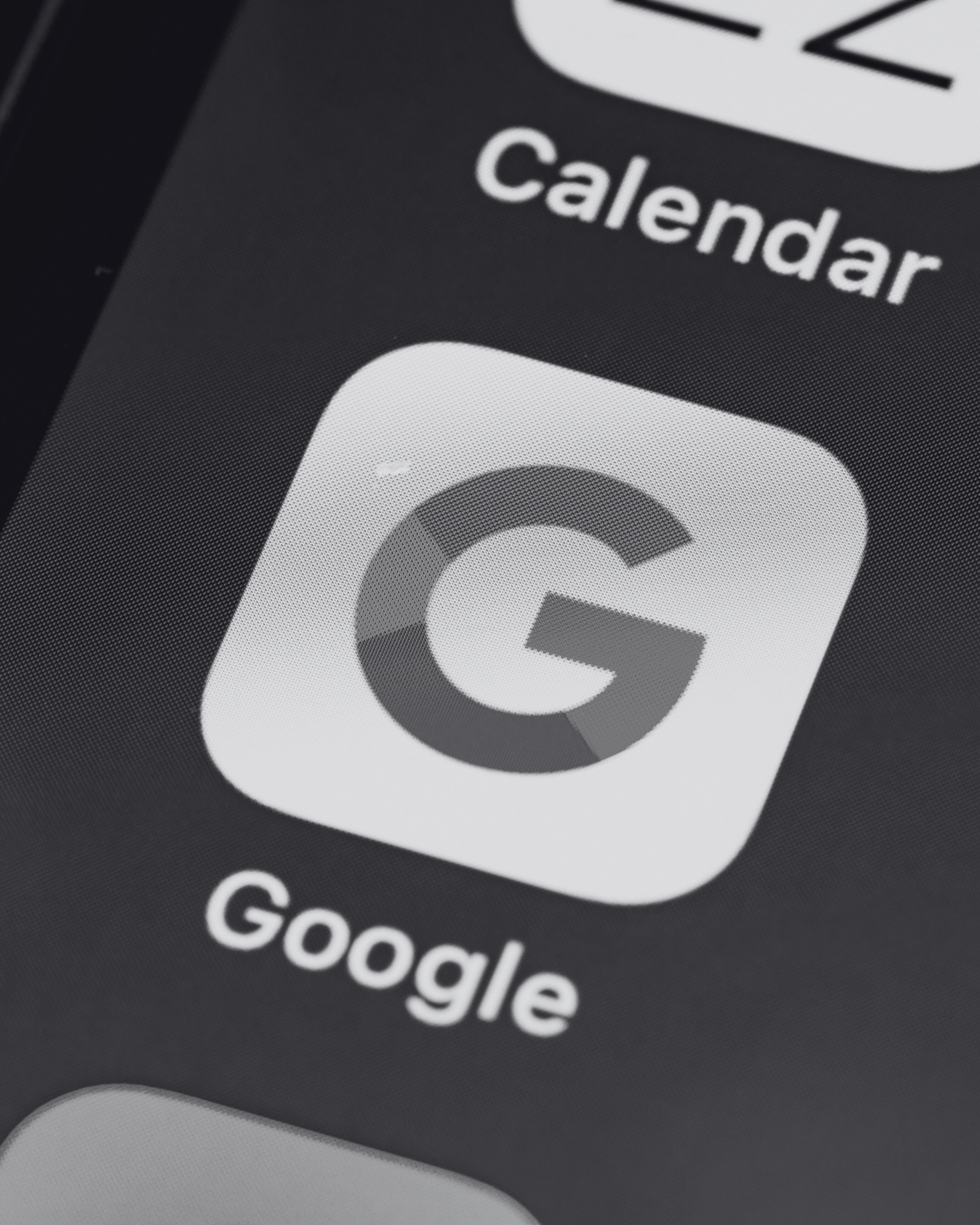 Close-up of a smartphone screen showing the Google app icon, representing paid advertising and Google Ads services by Seven4 Marketing.