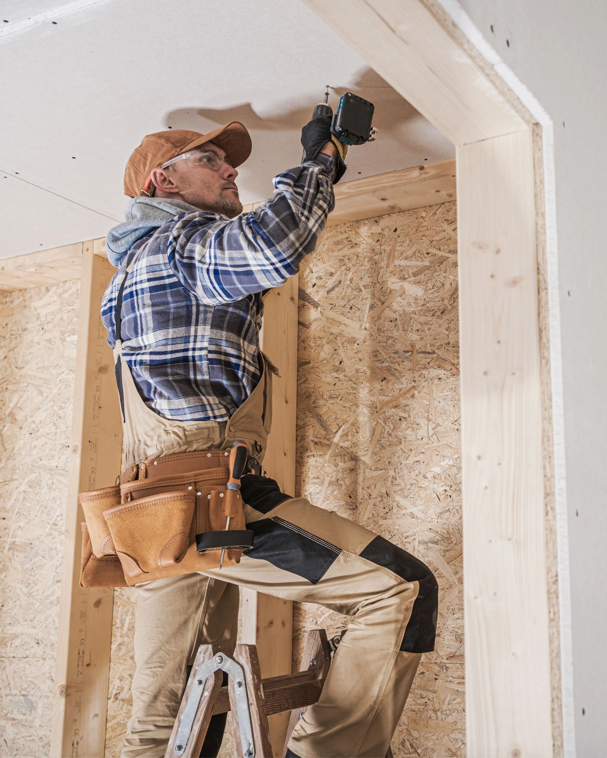 Professional contractor installing drywall during a residential home renovation project
