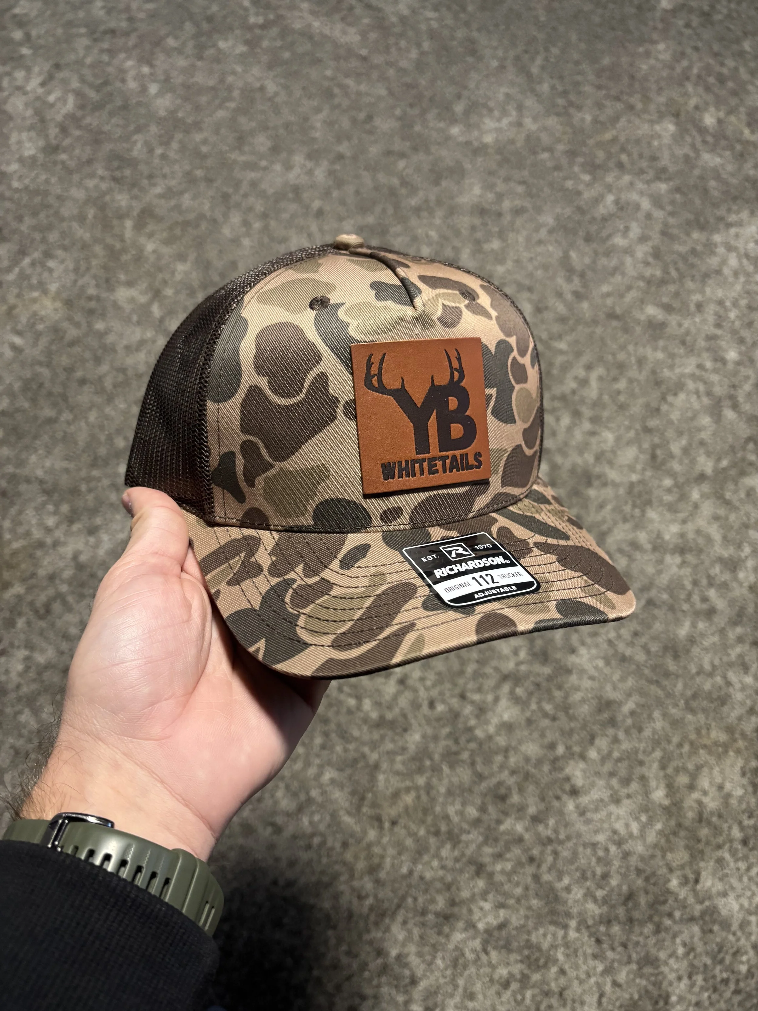 YB Whitetails camouflage hat with leather logo patch custom branded apparel design