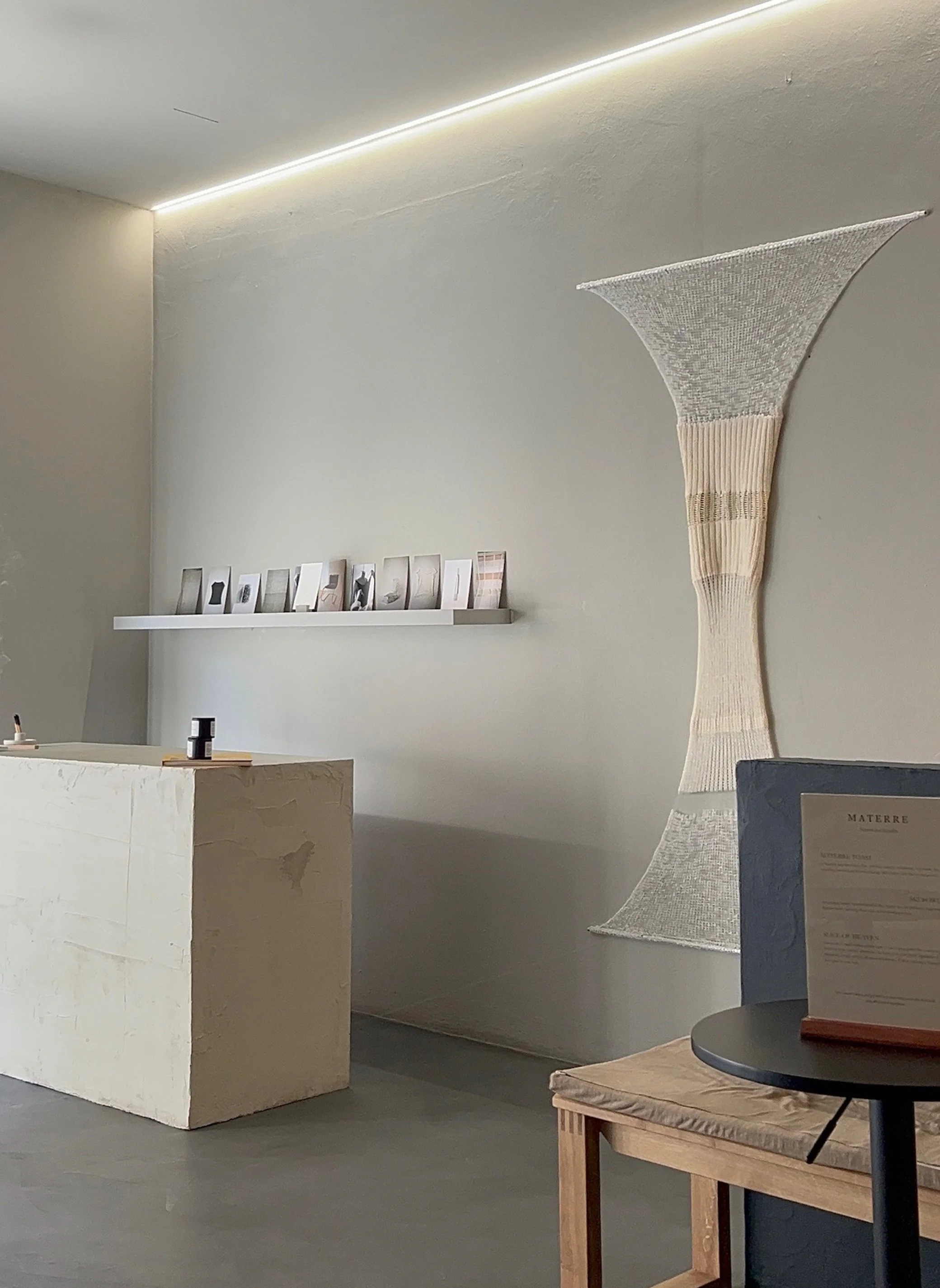 Minimal interior space with woven textile artwork during the first Materre pop-up in Kitzbühel, Austria