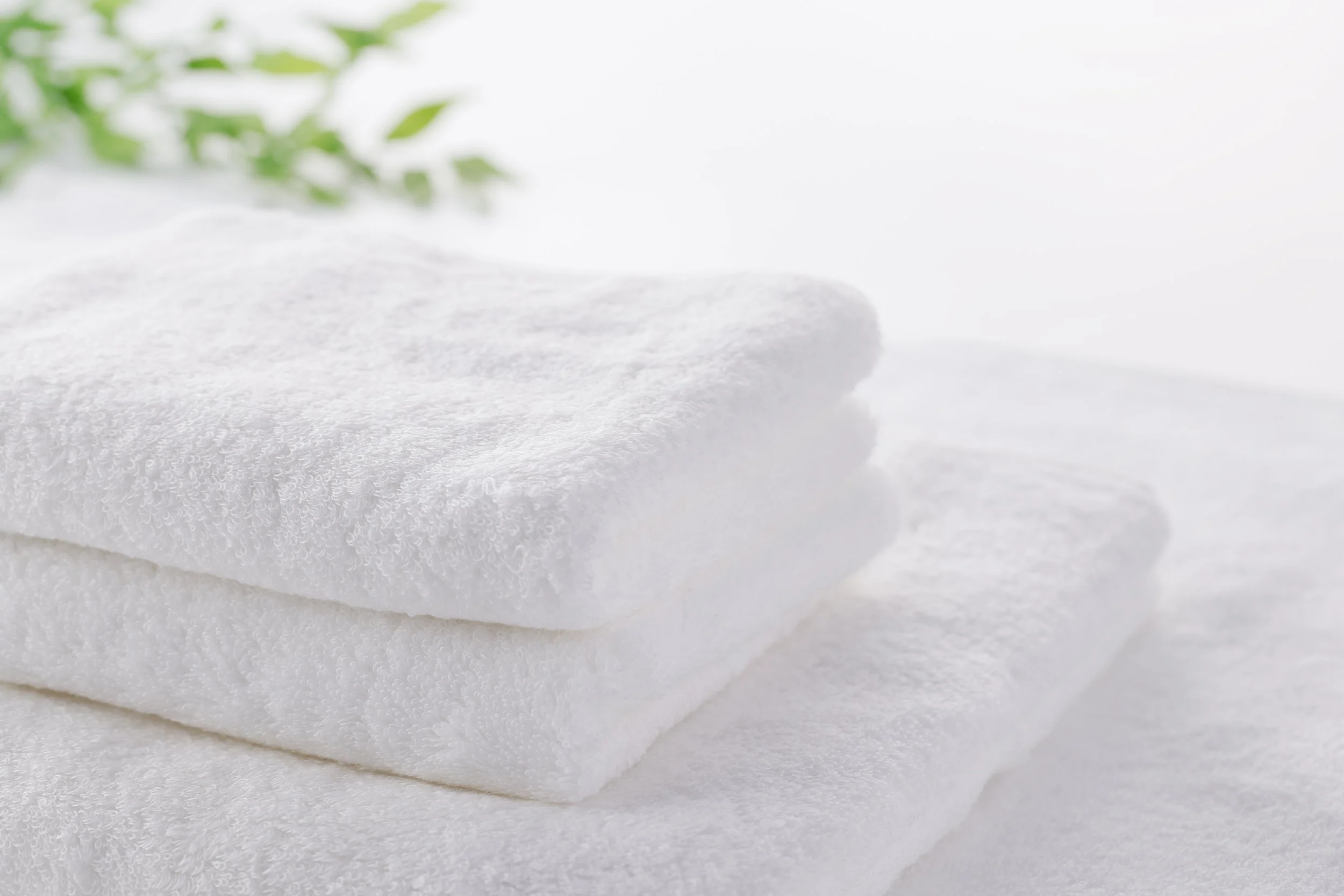 Three crisp, folded white towels