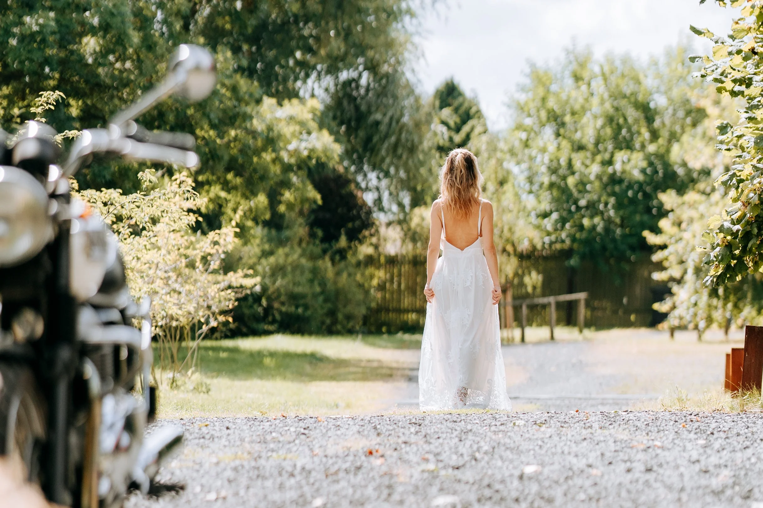 Laurie’s customers, Mariana and Carmen holding hands on a green lawn on their wedding day.