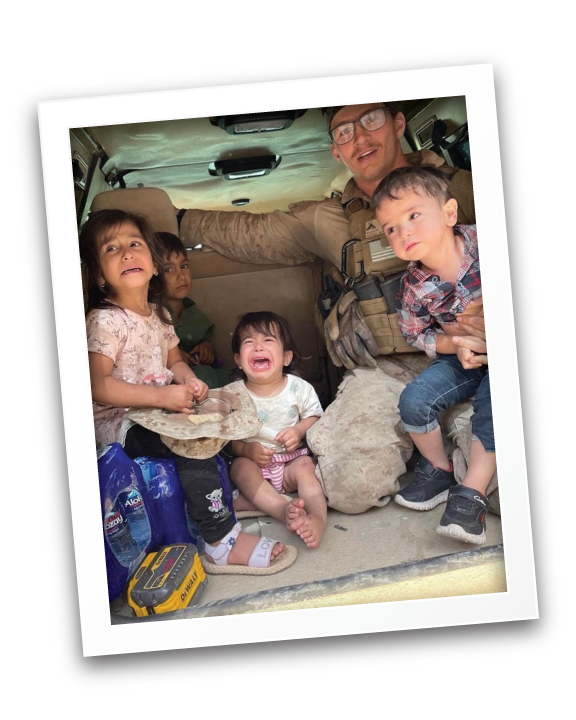 Max with a small group of children inside a vehicle, with some children crying and others sitting silently.