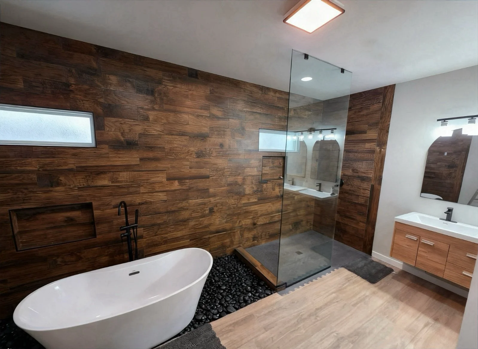 Modern bathroom with a white freestanding bathtub, a wood-paneled accent wall, a glass shower enclosure, and a floating vanity with two sinks and mirrors.