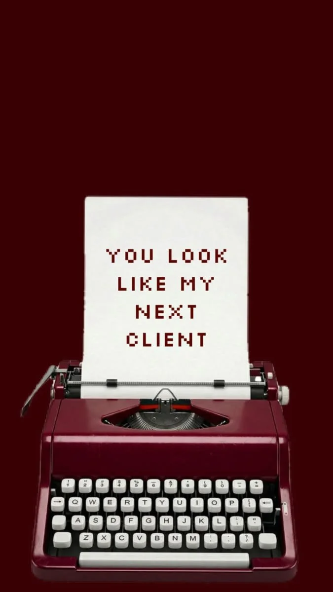 A red typewriter printing out a note that says, "You look like my next client" on white paper, with a dark red background.
