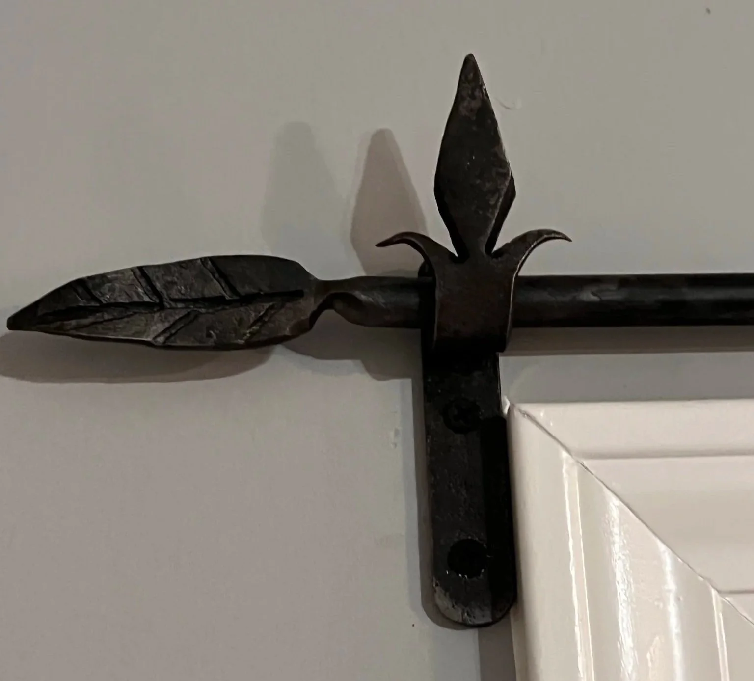 Custom hand forged curtain rod and mounting bracket.