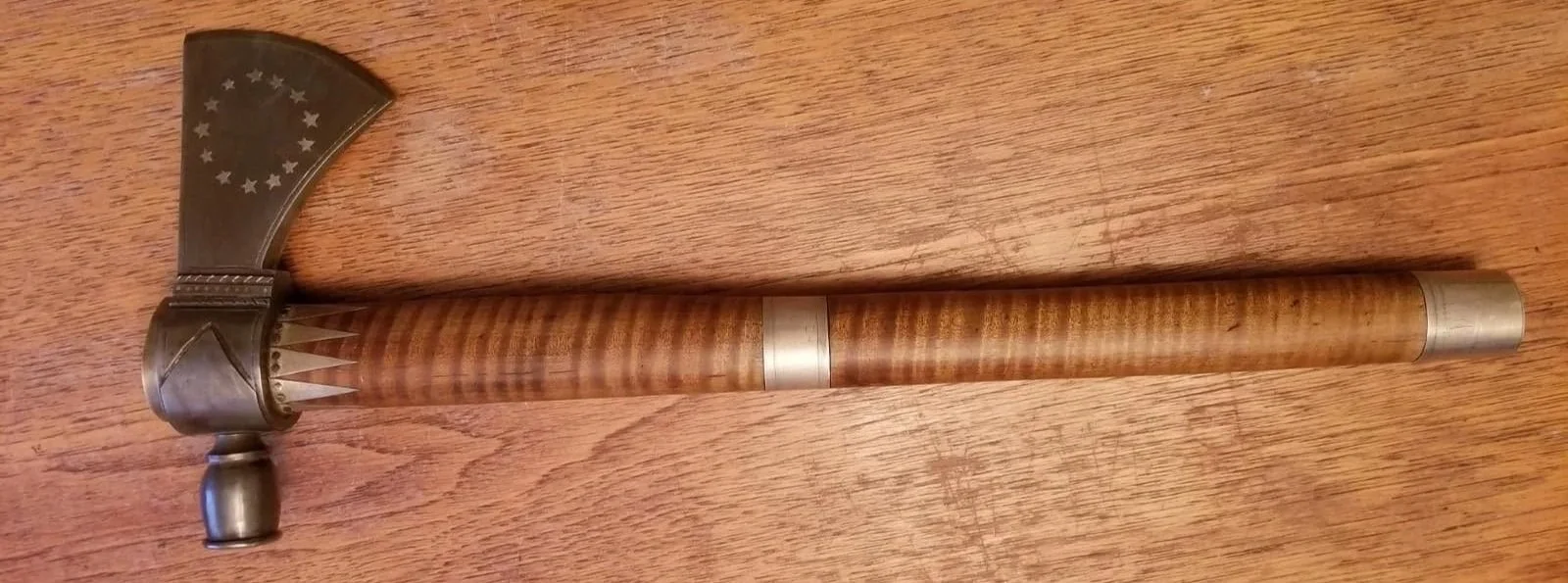 Completed pipe tomahawk featuring silver inlay and a hand-finished handle stars