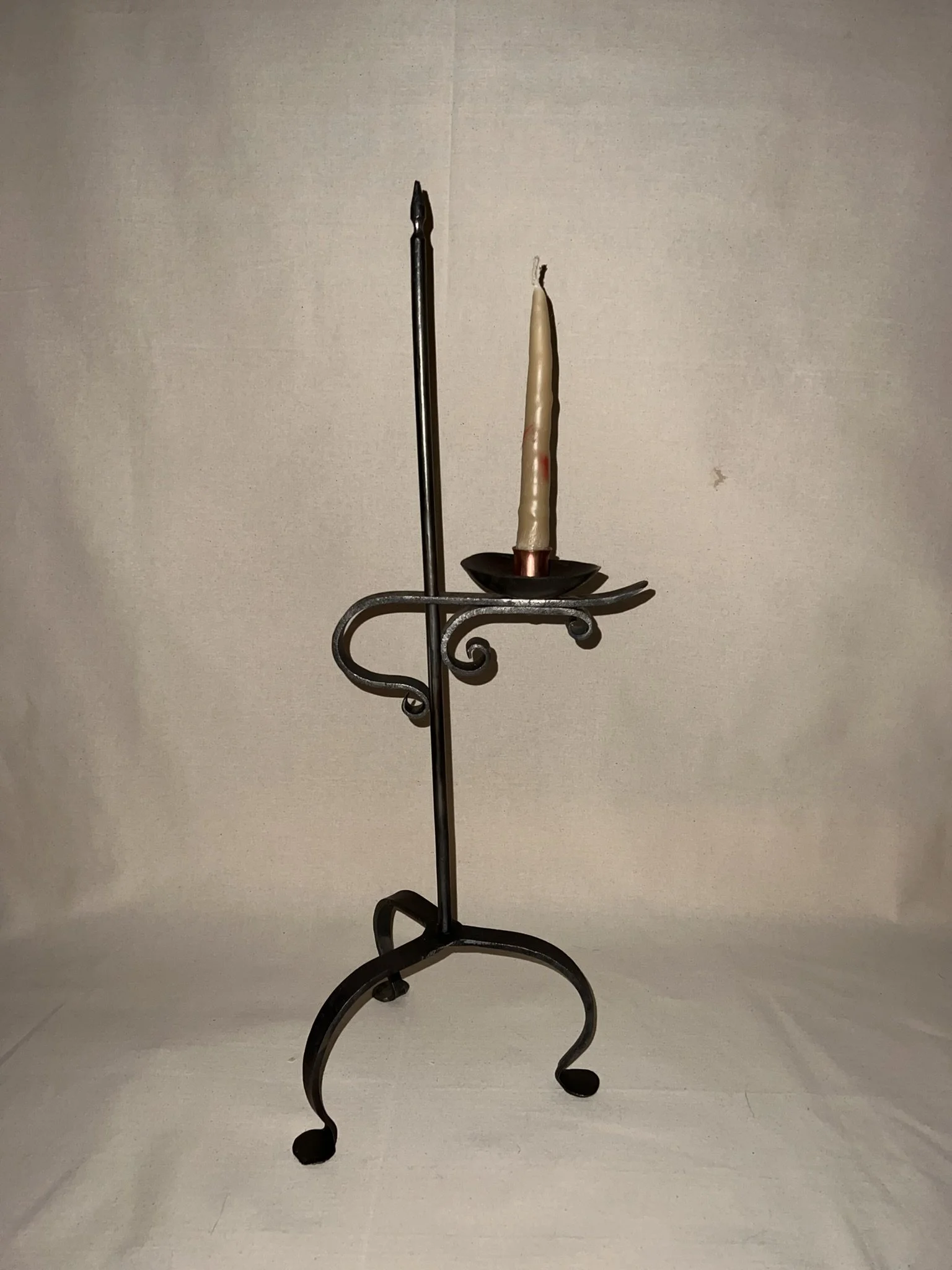 Hand-forged colonial candle holder in mixed media steel and copper.