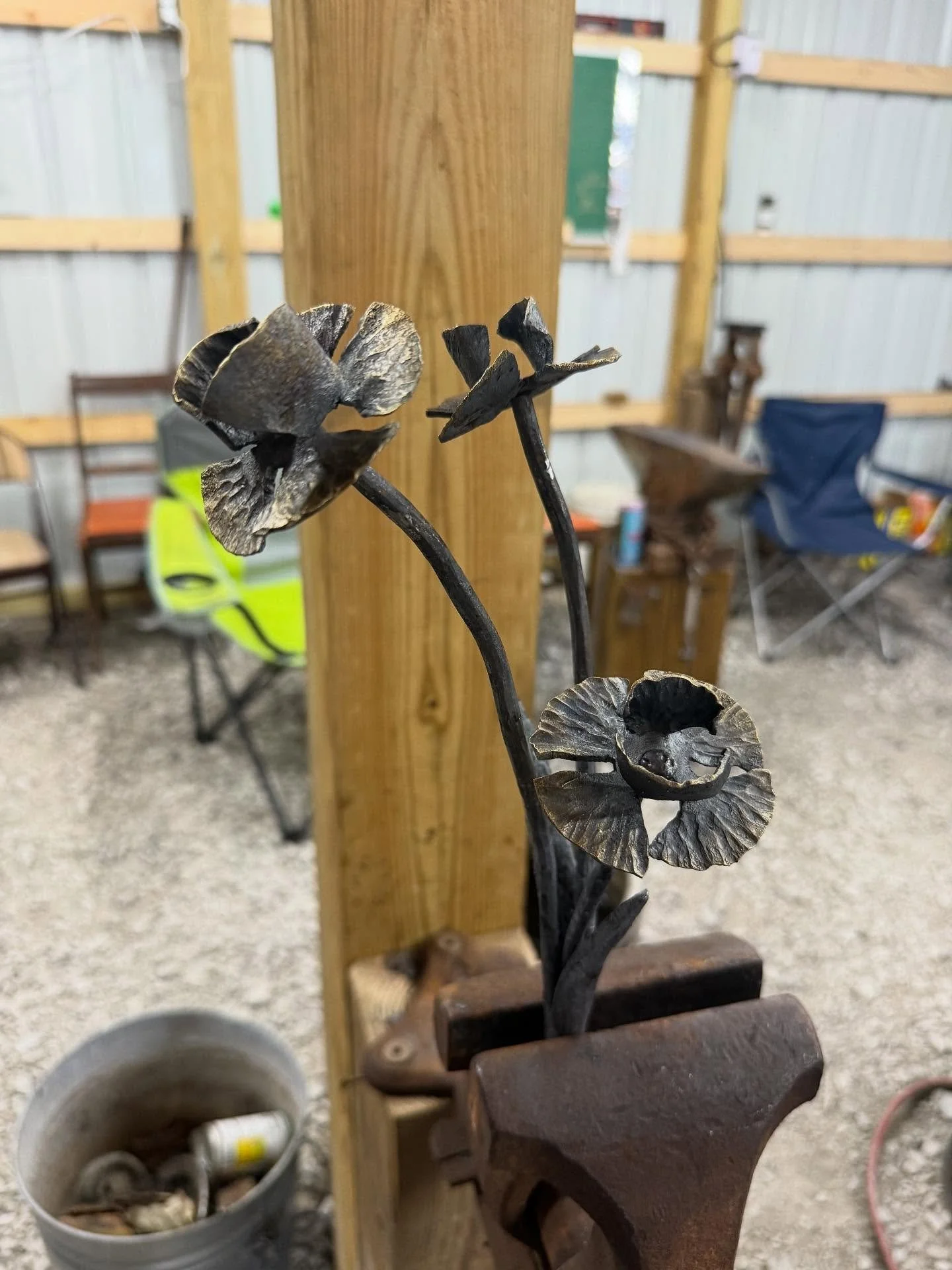 Hand-forged daffodil-inspired bouquet in iron, featuring forge-welded stems and leaves.