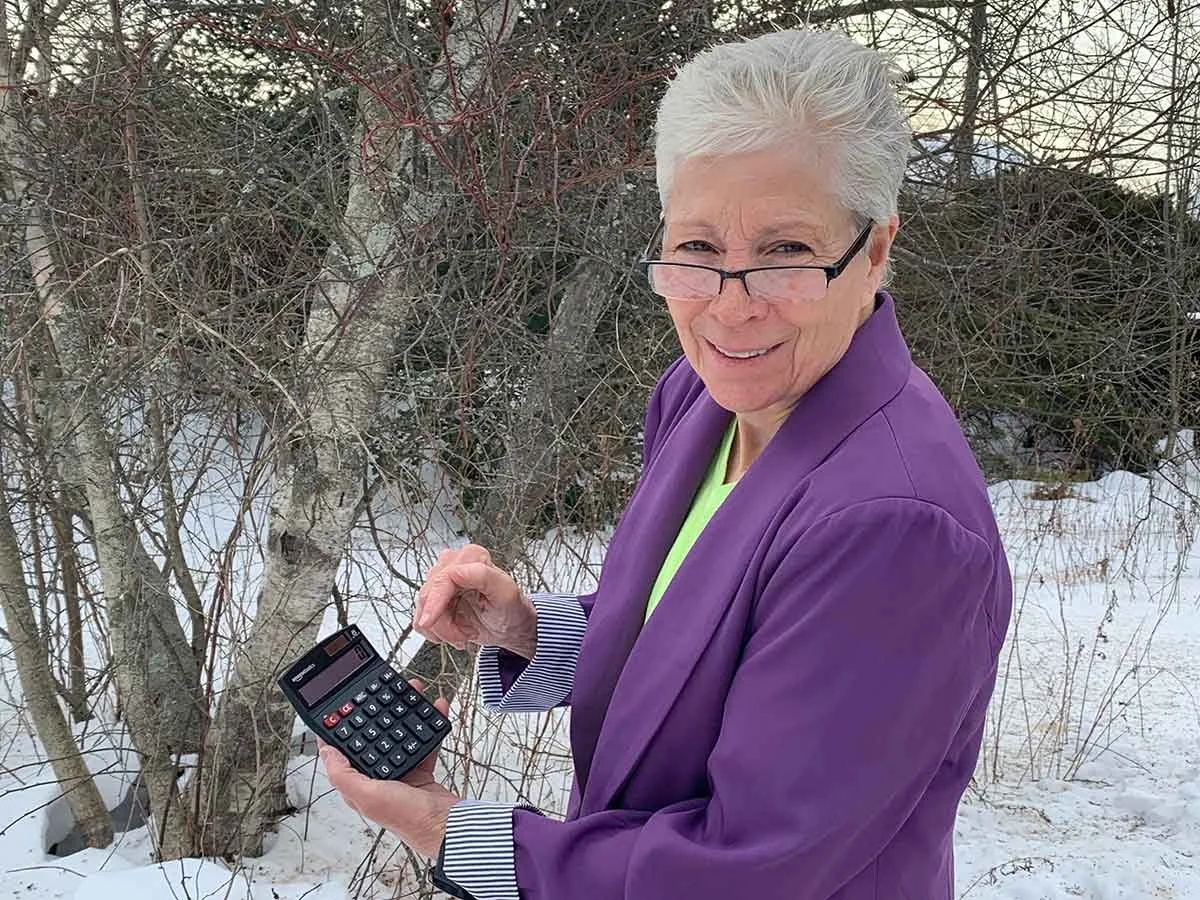 Trish Hiller holding a calculator