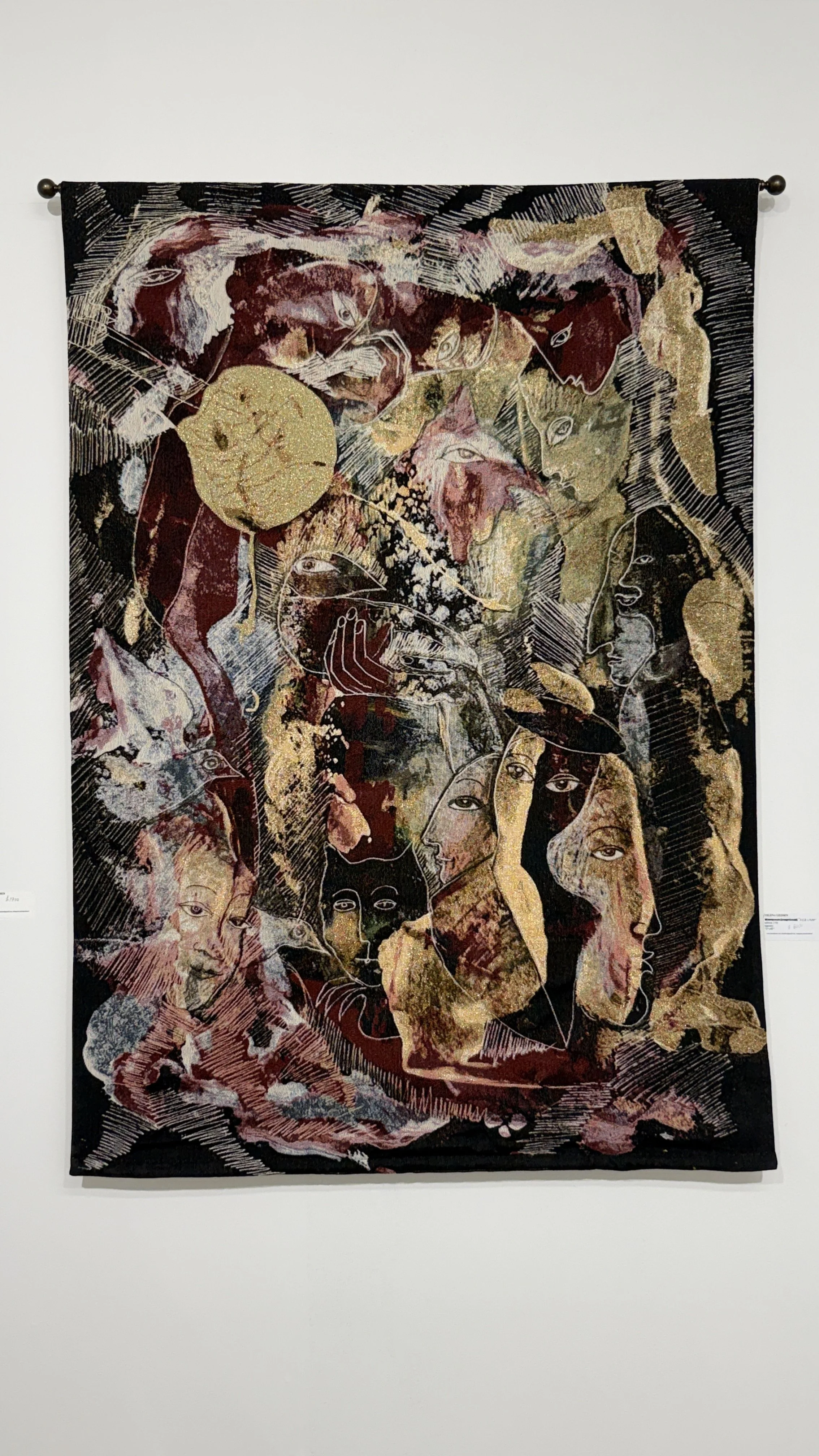 Red Room, a 72 x 48 inch fine art tapestry by Yelena Lezhen, featuring overlapping symbolic faces, imaginative figures, and gold accents against a dark burgundy and black background.