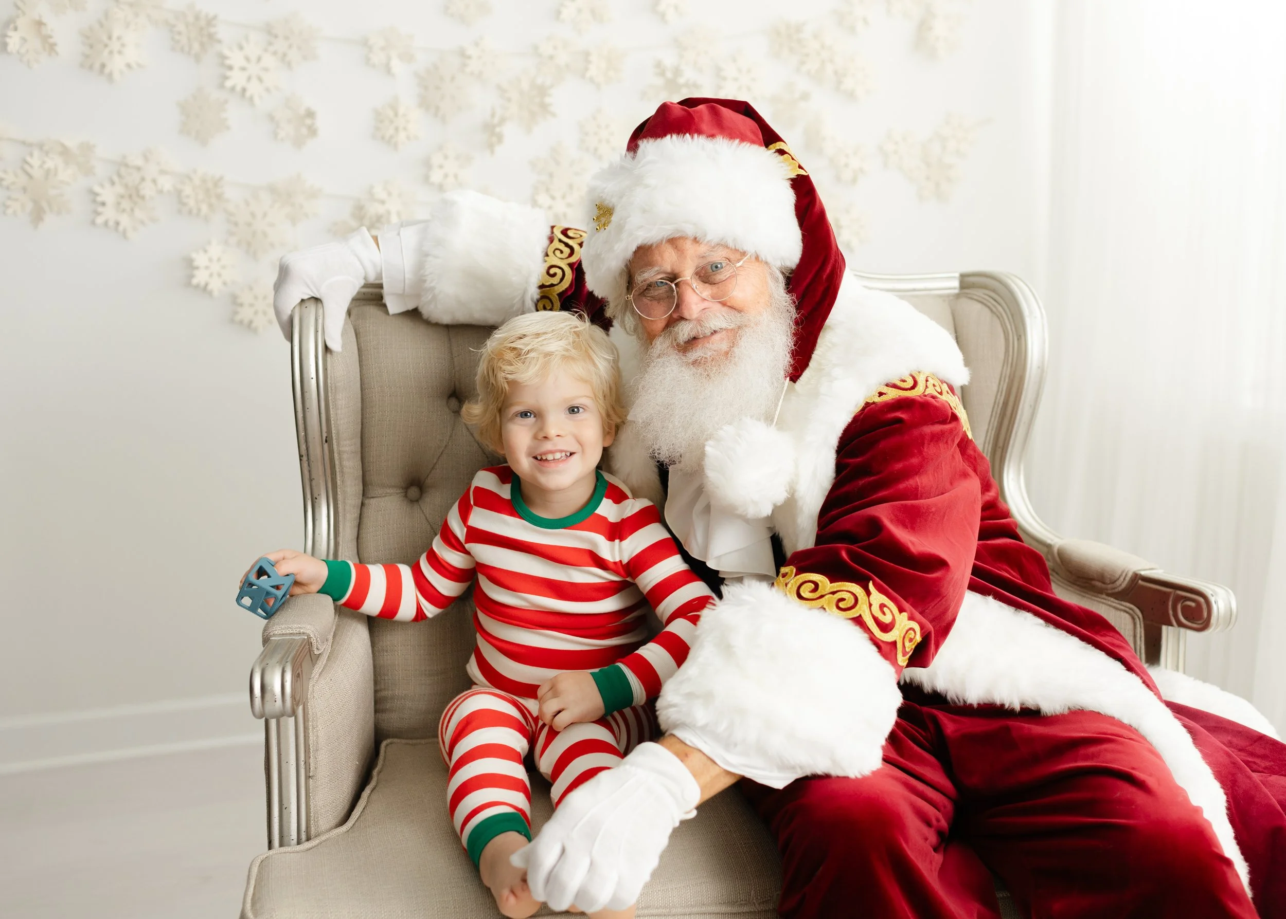Young boy sitting beside Santa during a private Santa photo session in Forest, Virginia