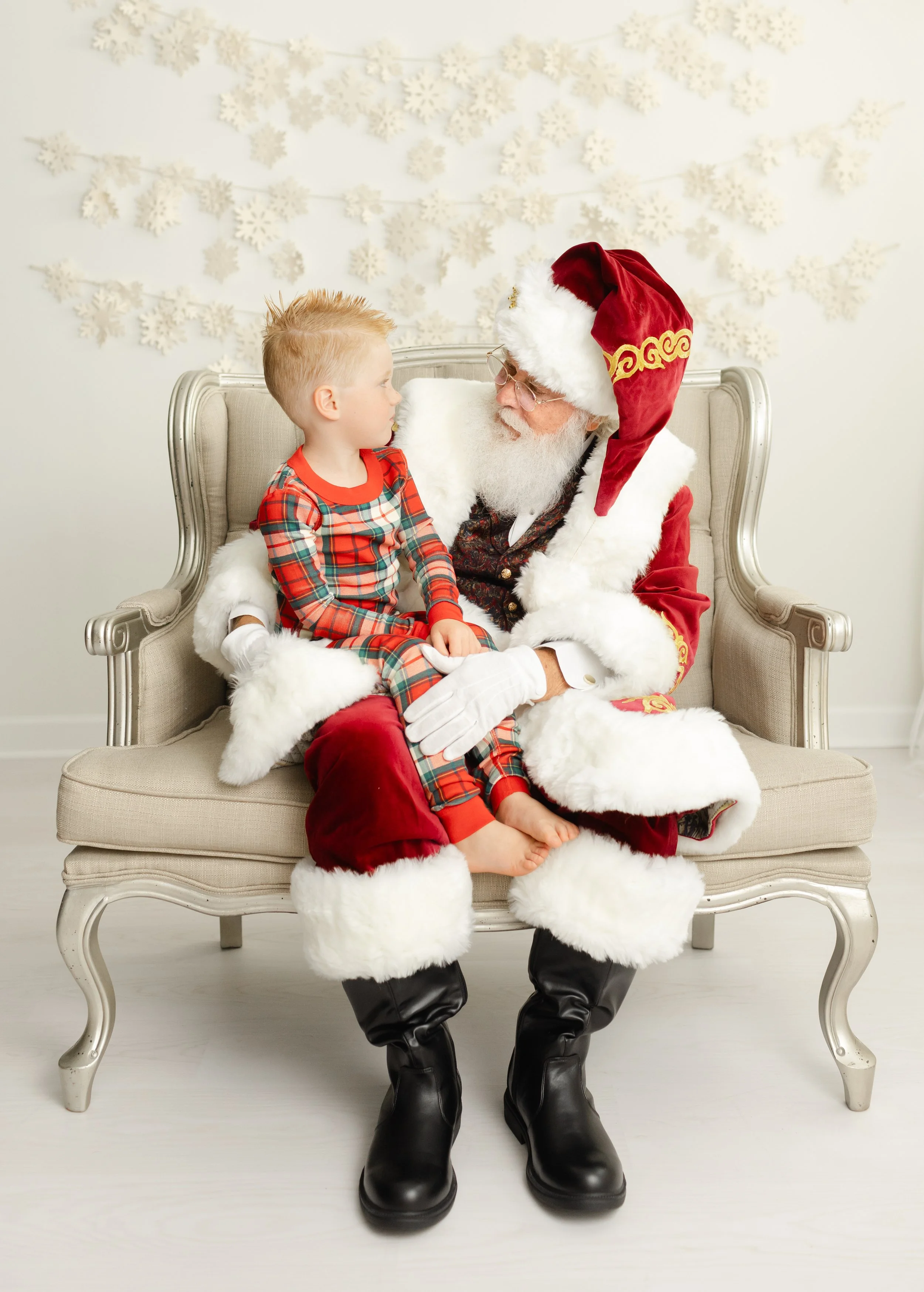 Little boy chatting with Santa during a private Christmas studio visit